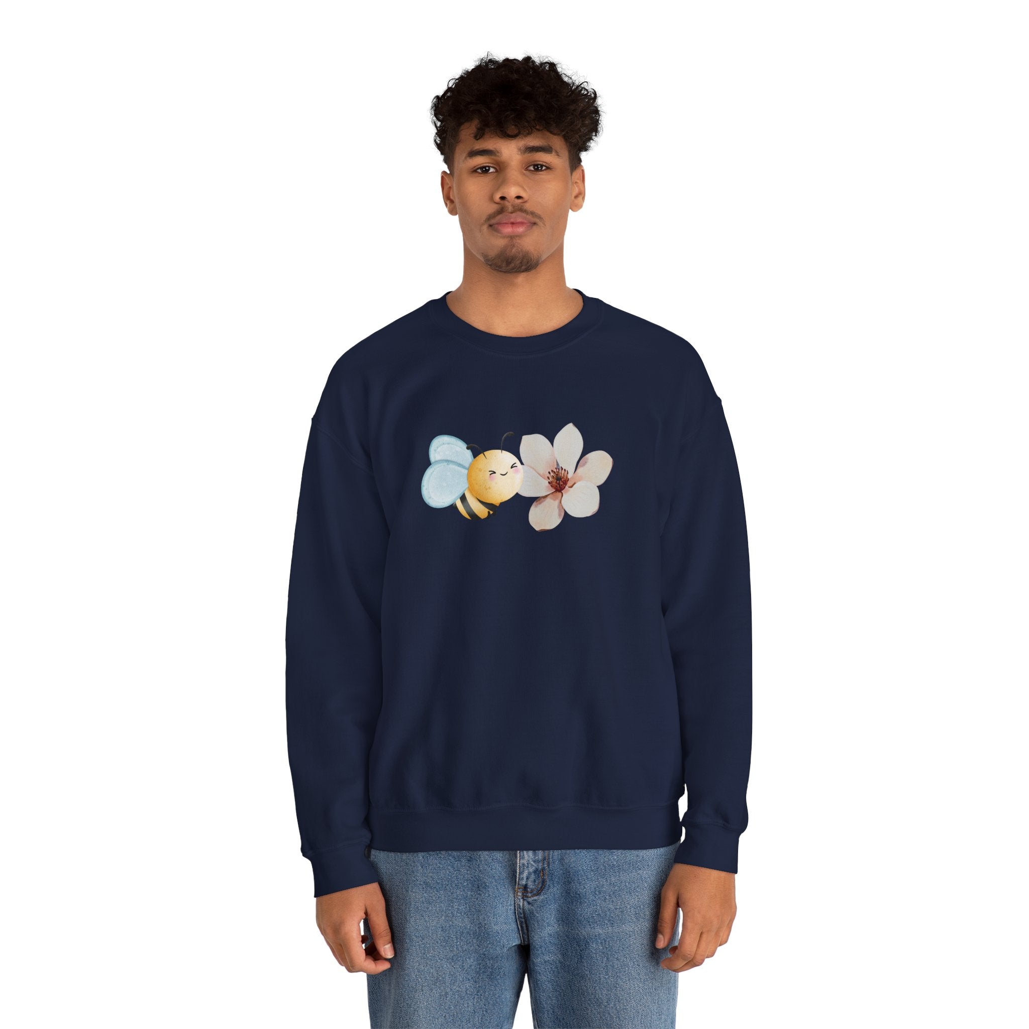 Person wearing a navy blue sweatshirt with bee and flower pattern on a white background