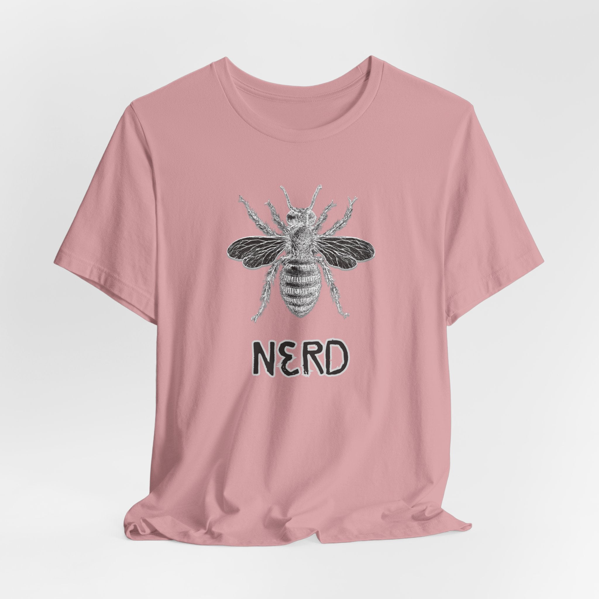 Pink t-shirt with bee graphic and 'NERD' text on a light gray background