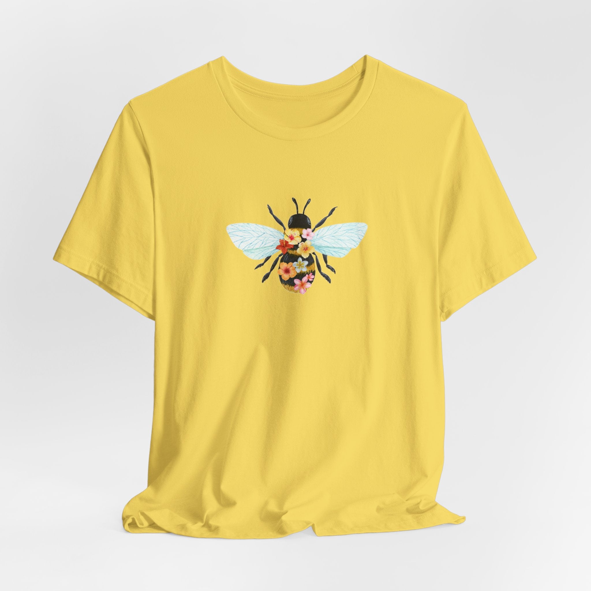 Yellow t-shirt with a bee graphic on a light gray background