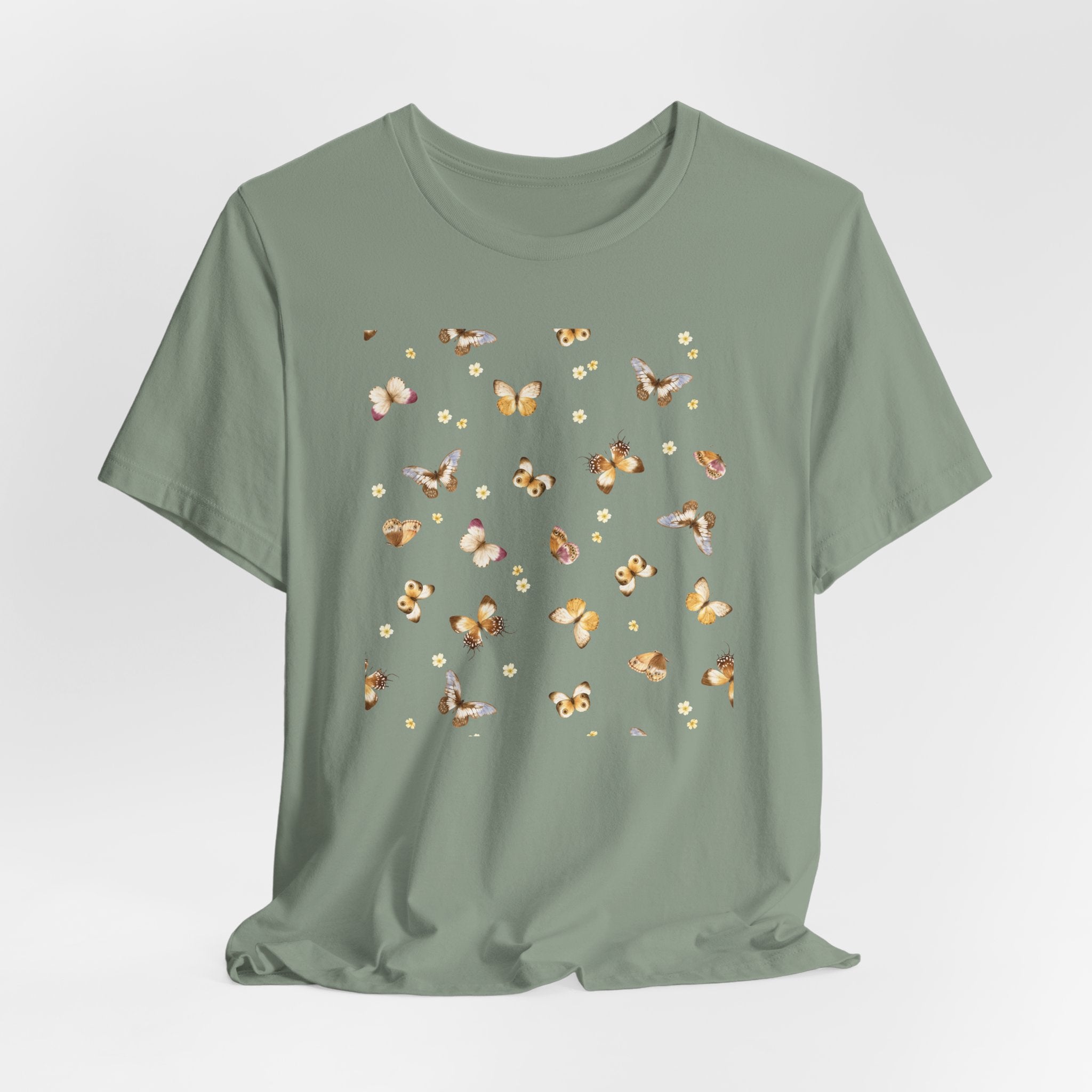 Green t-shirt with butterfly pattern on a light gray background