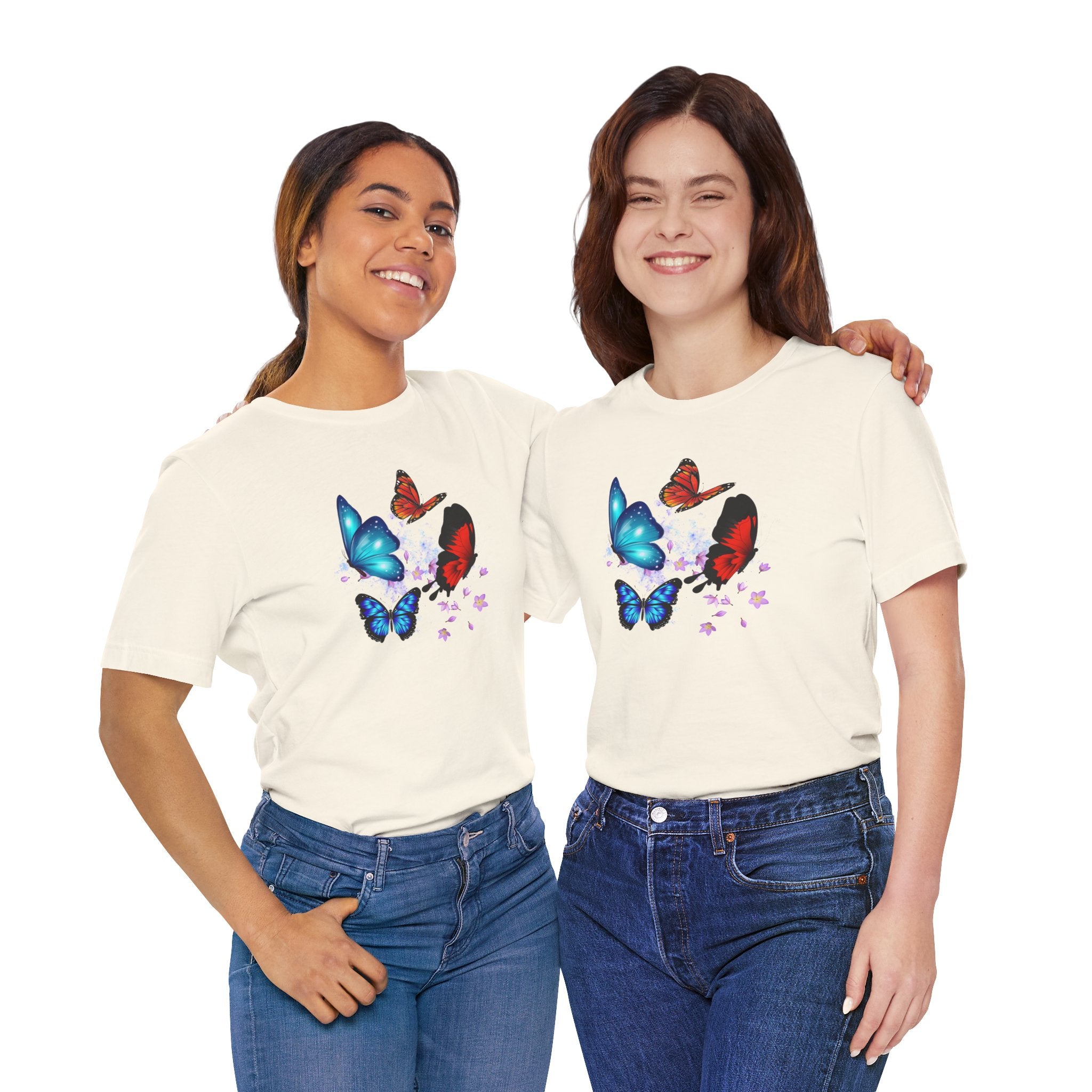 Two women wearing cream t-shirts with butterfly designs on a white background