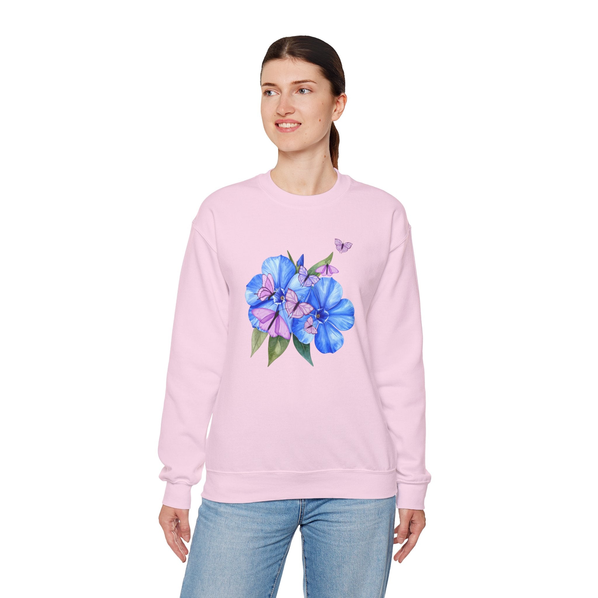 Woman wearing a pink sweatshirt with a floral design on a white background