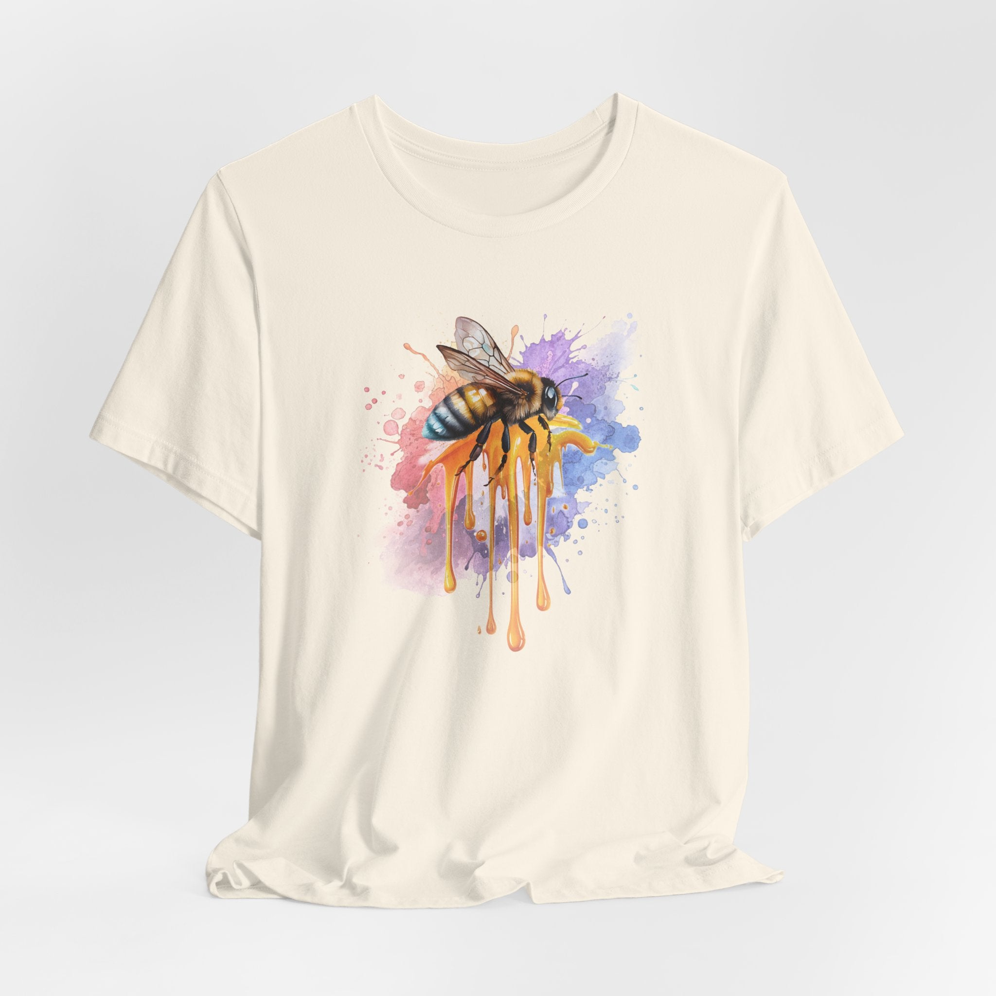 Beige t-shirt with a colorful bee design on a light gray background