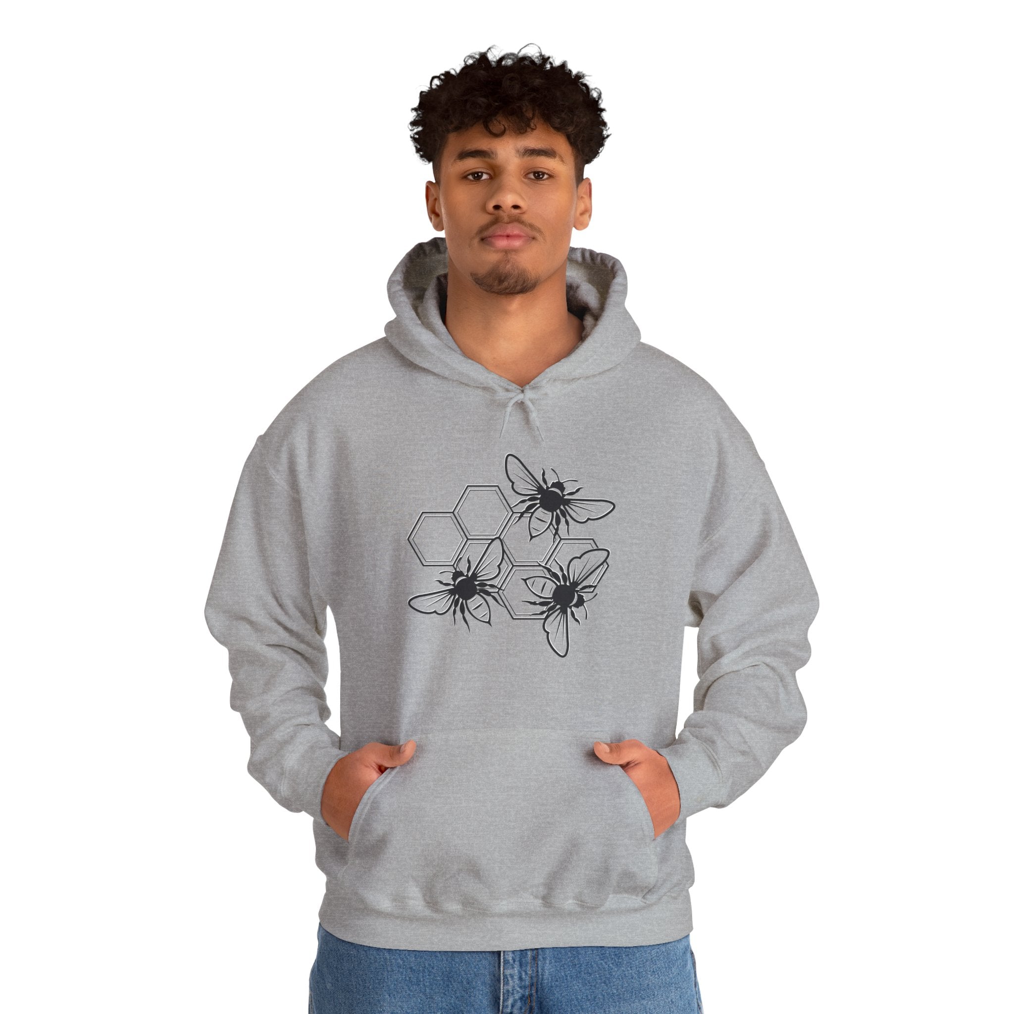 Person wearing a gray hoodie with bee design on a white background