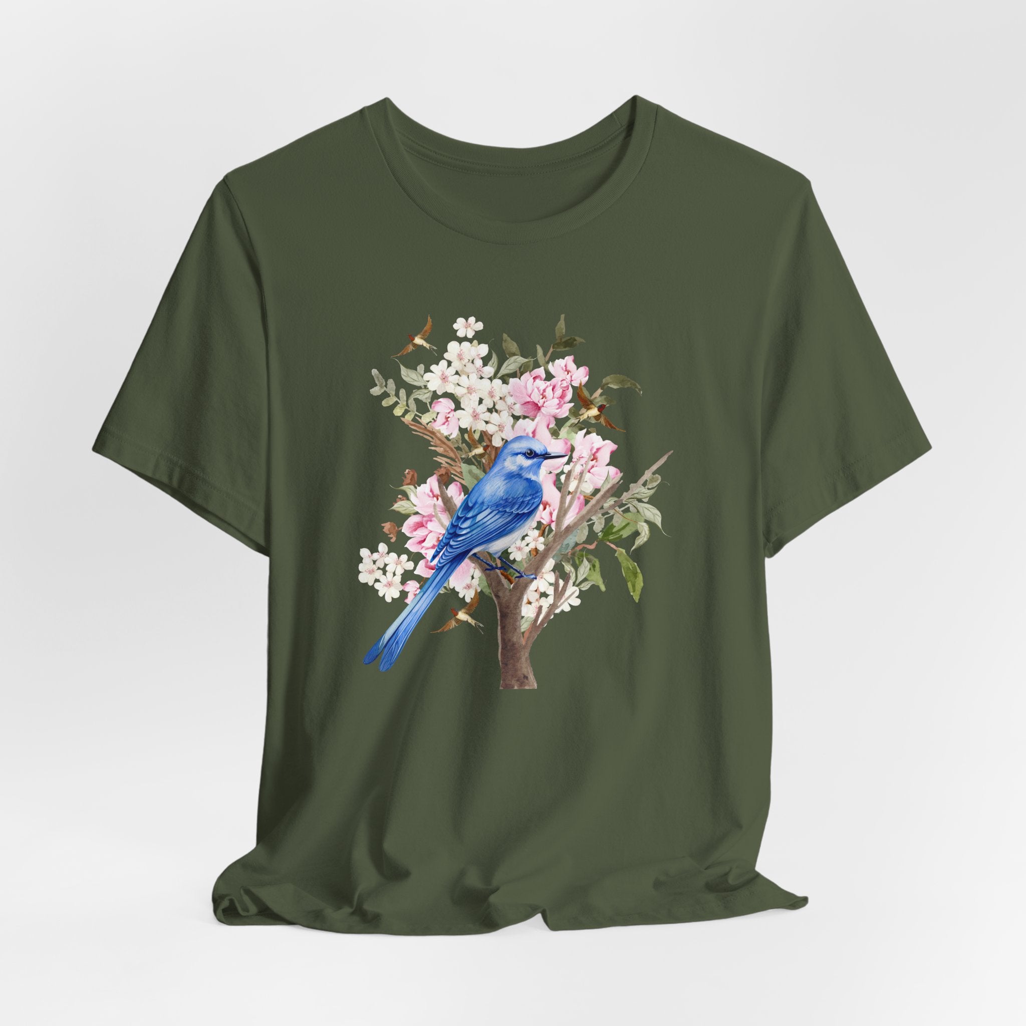 Green t-shirt with a blue bird and floral design on a white background