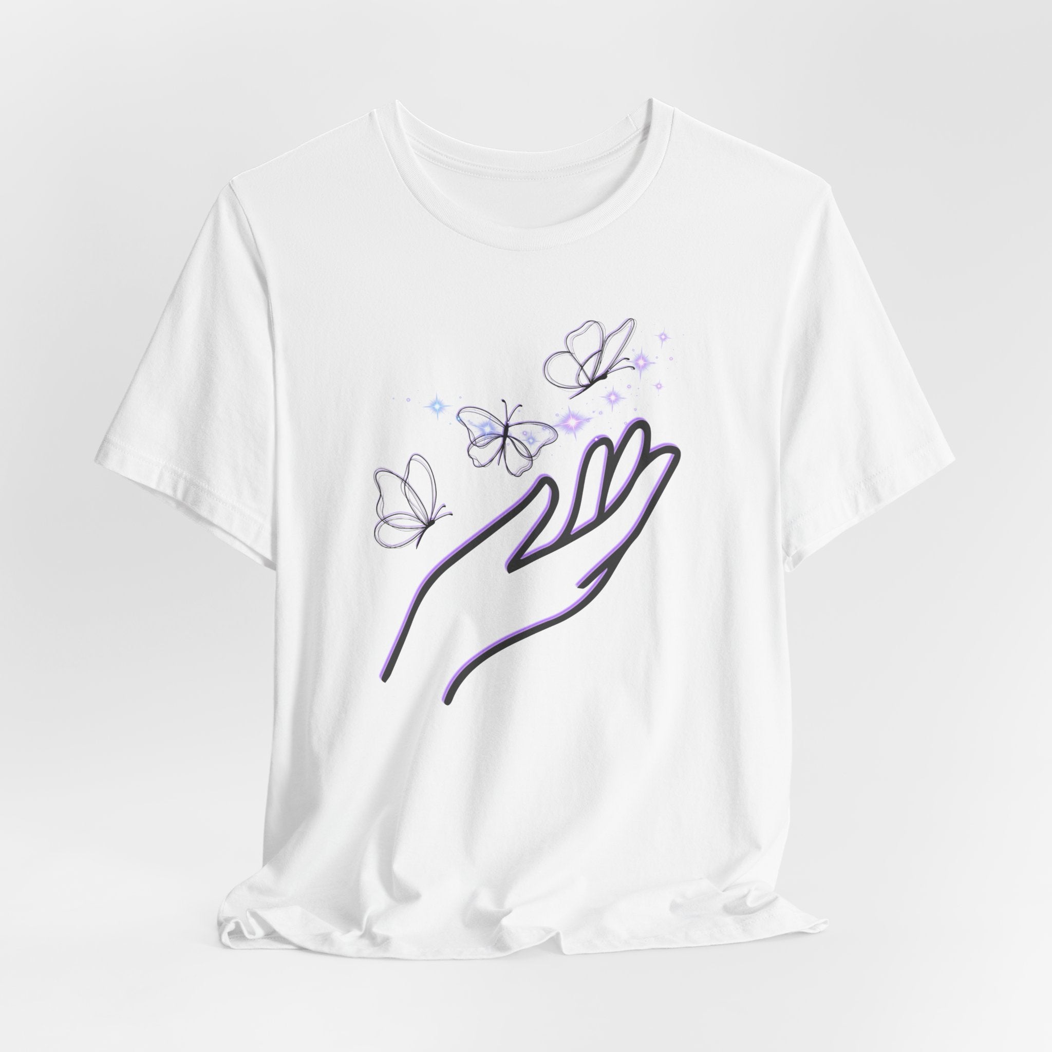 White t-shirt with a design of a hand holding butterflies on a light gray background