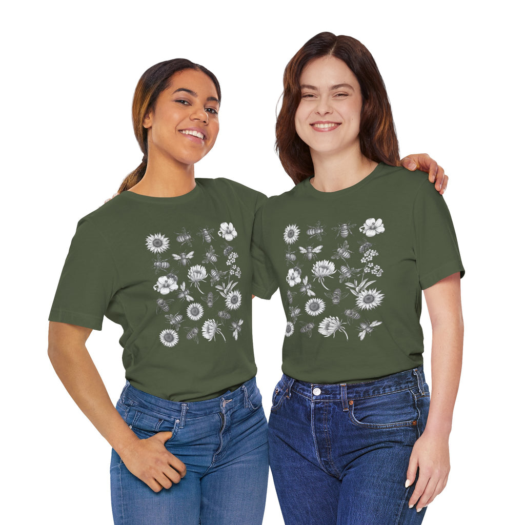 Two women wearing green t-shirts with floral patterns on a white background