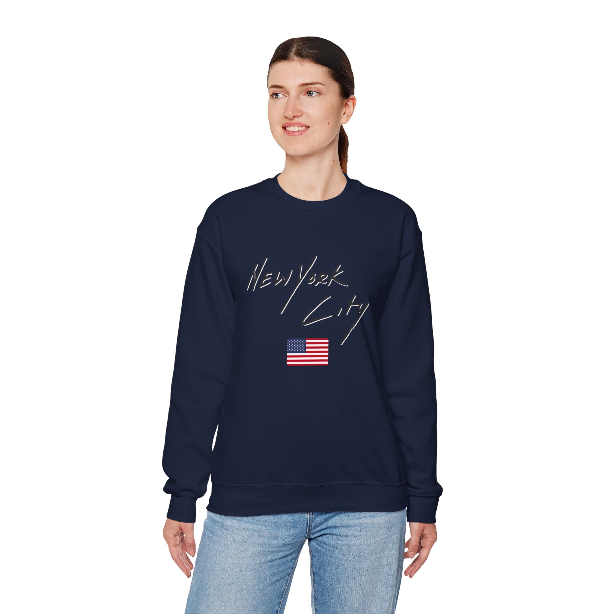 Person wearing a navy blue sweatshirt with 'New York City' and an American flag design on a white background