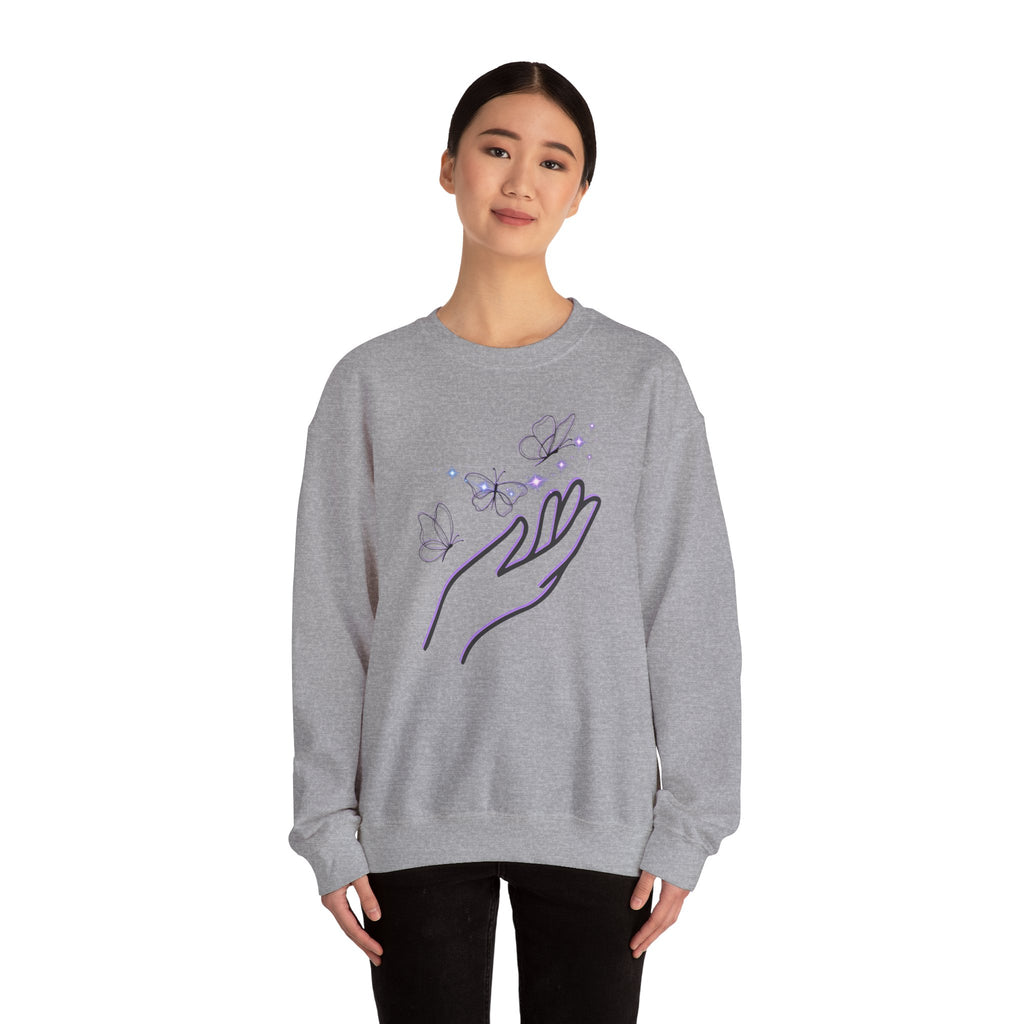 Person wearing a gray sweatshirt with a hand and butterfly design on a white background