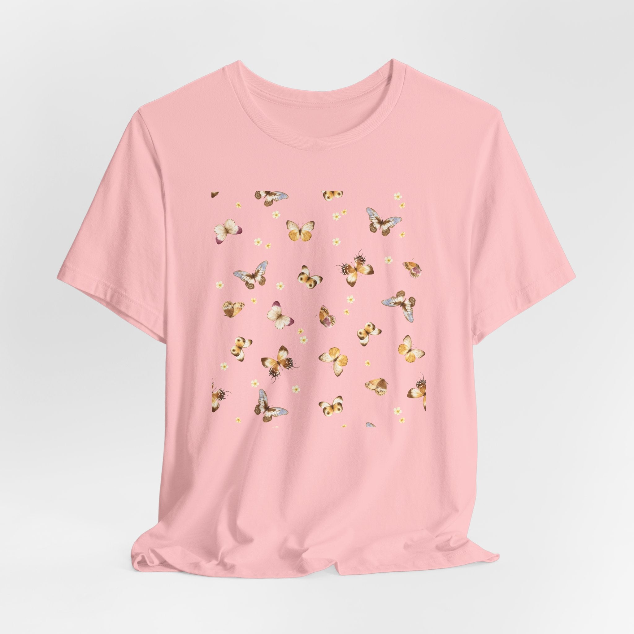 Pink t-shirt with butterfly pattern on a light gray background