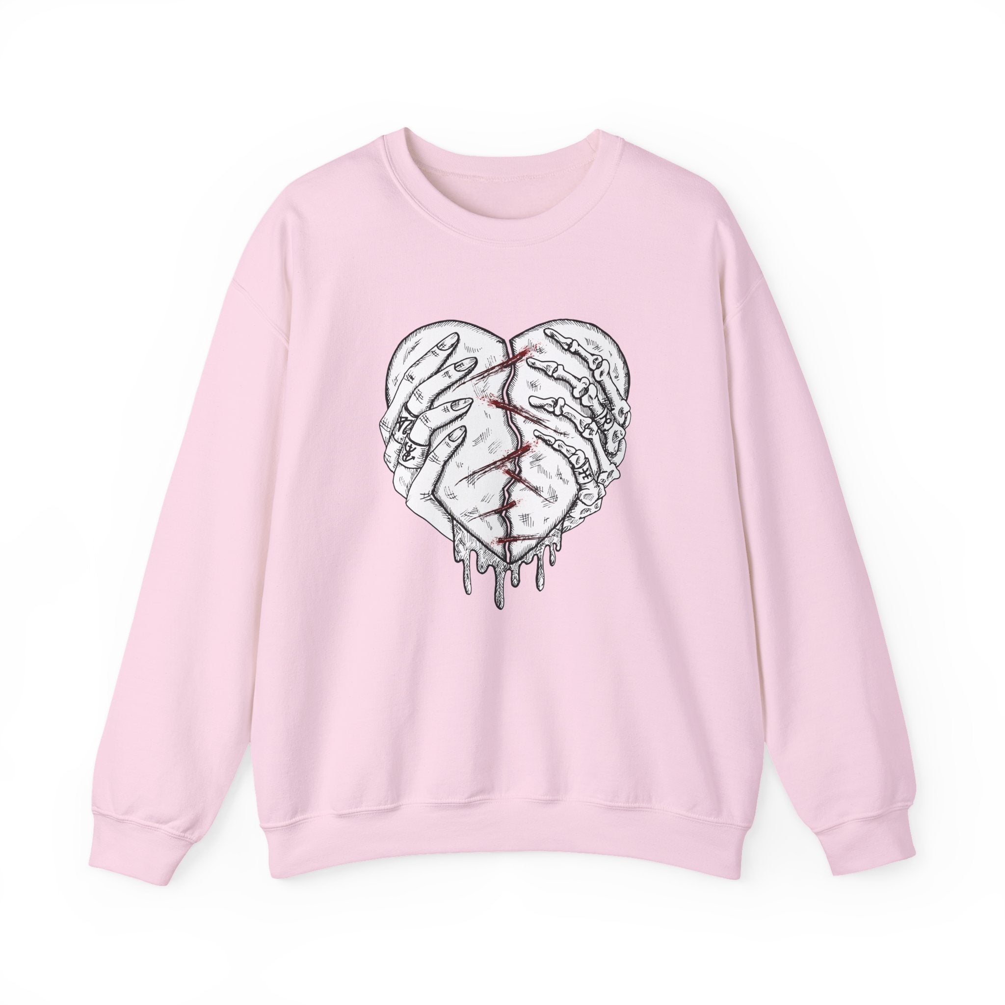 Pink sweatshirt with a graphic design of a broken heart on a white background