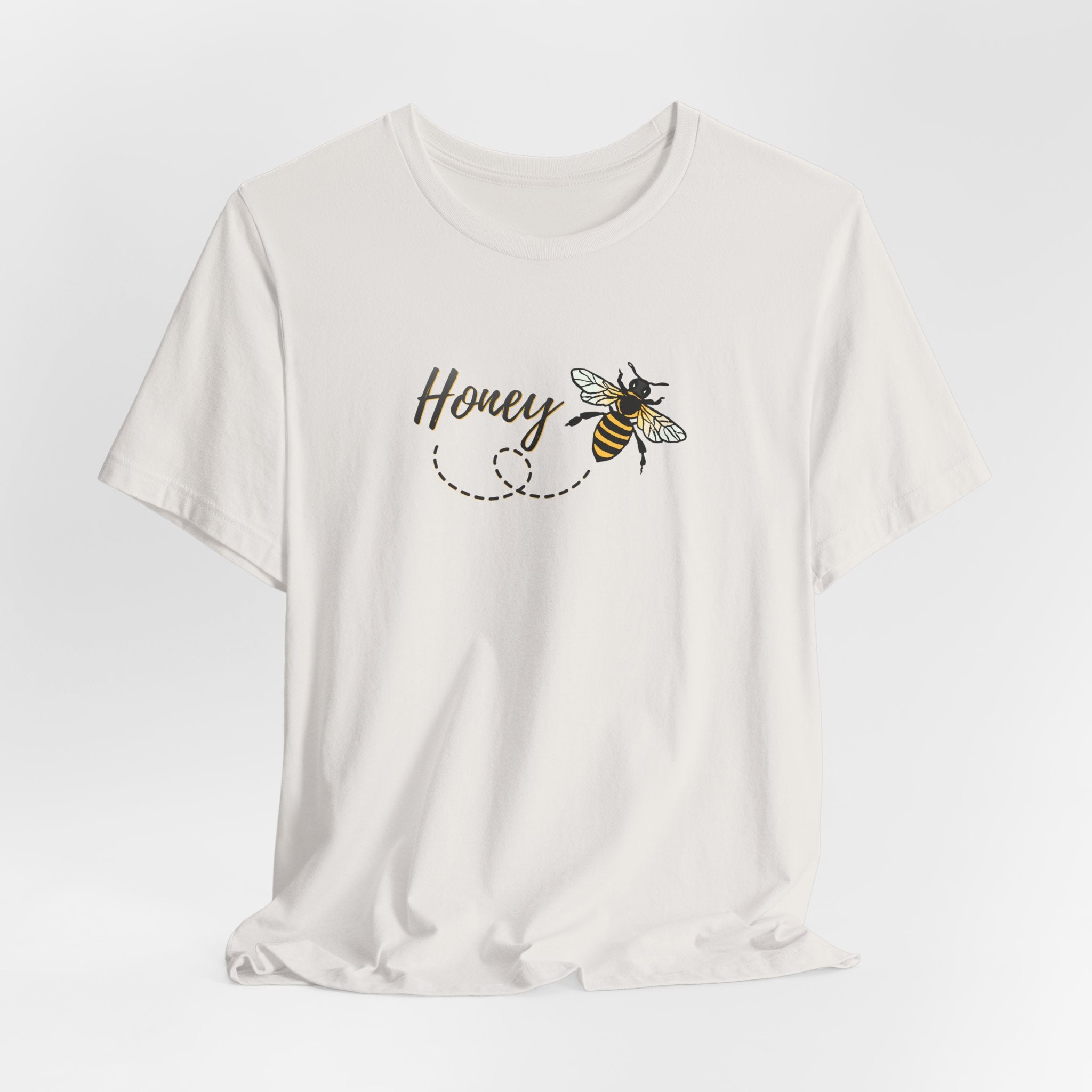 White t-shirt with 'Honey' and bee design on a light gray background