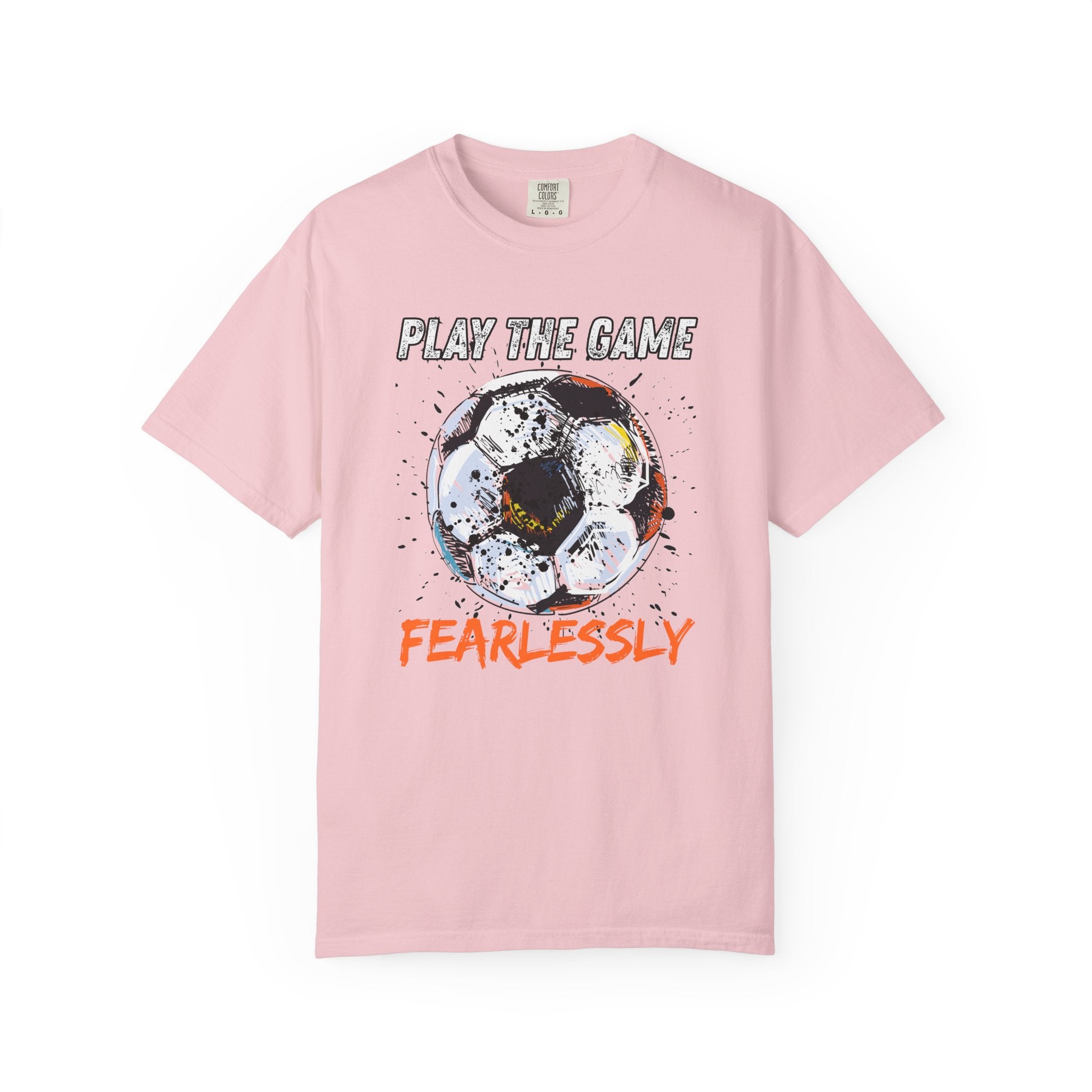 Pink t-shirt with dirty soccer ball graphic and play the game fearlessly text on a white background