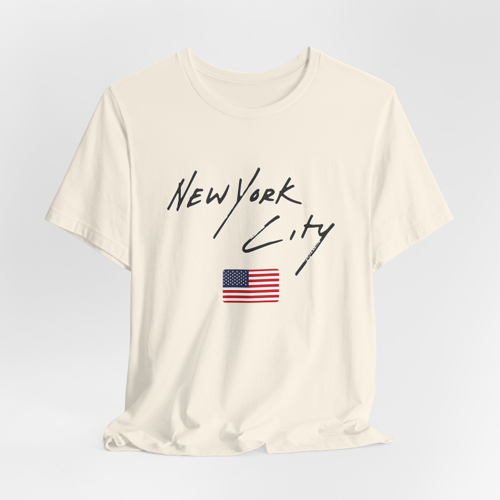 White t-shirt with 'New York City' text and American flag on a light gray background