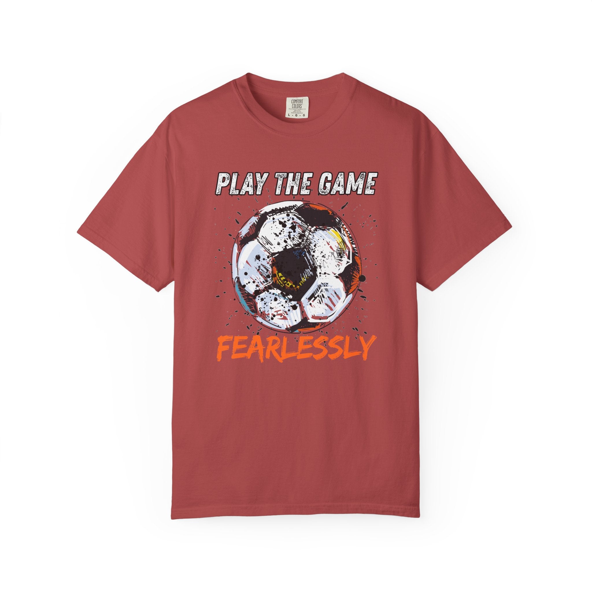 Red orange t-shirt with dirty soccer ball graphic and play the game fearlessly text on a white background