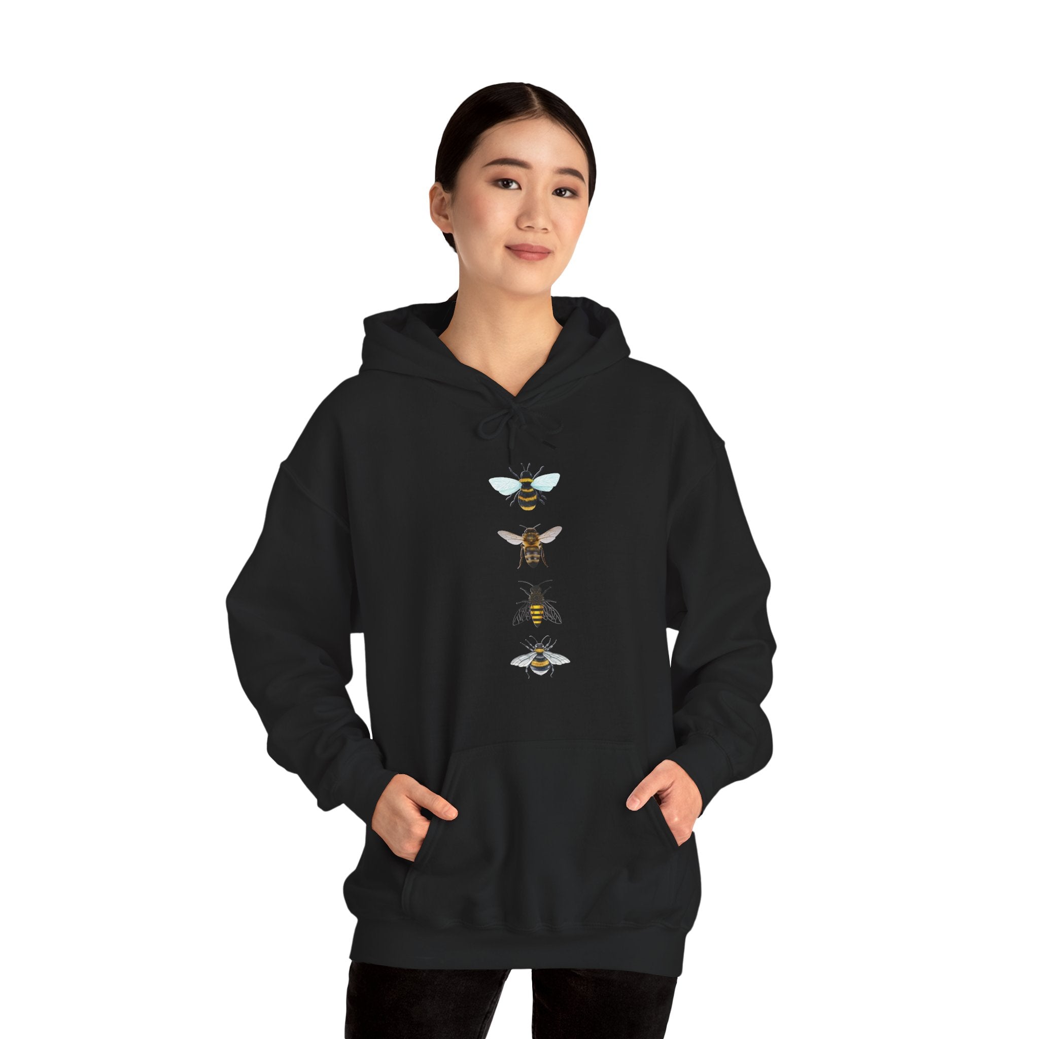 Person wearing a black hoodie with bee graphic on a white background