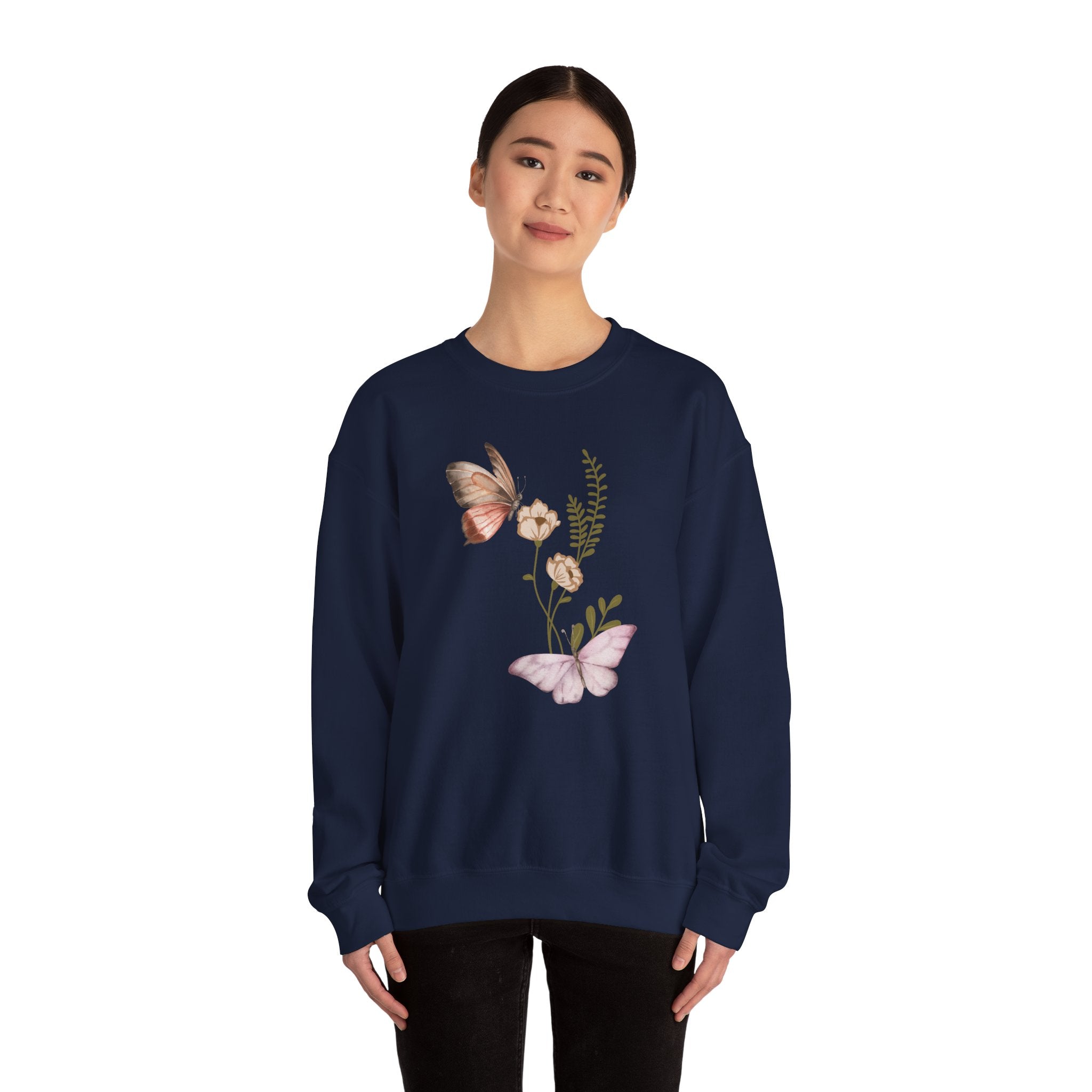 Navy blue sweatshirt with butterfly and floral design worn by a model on a white background