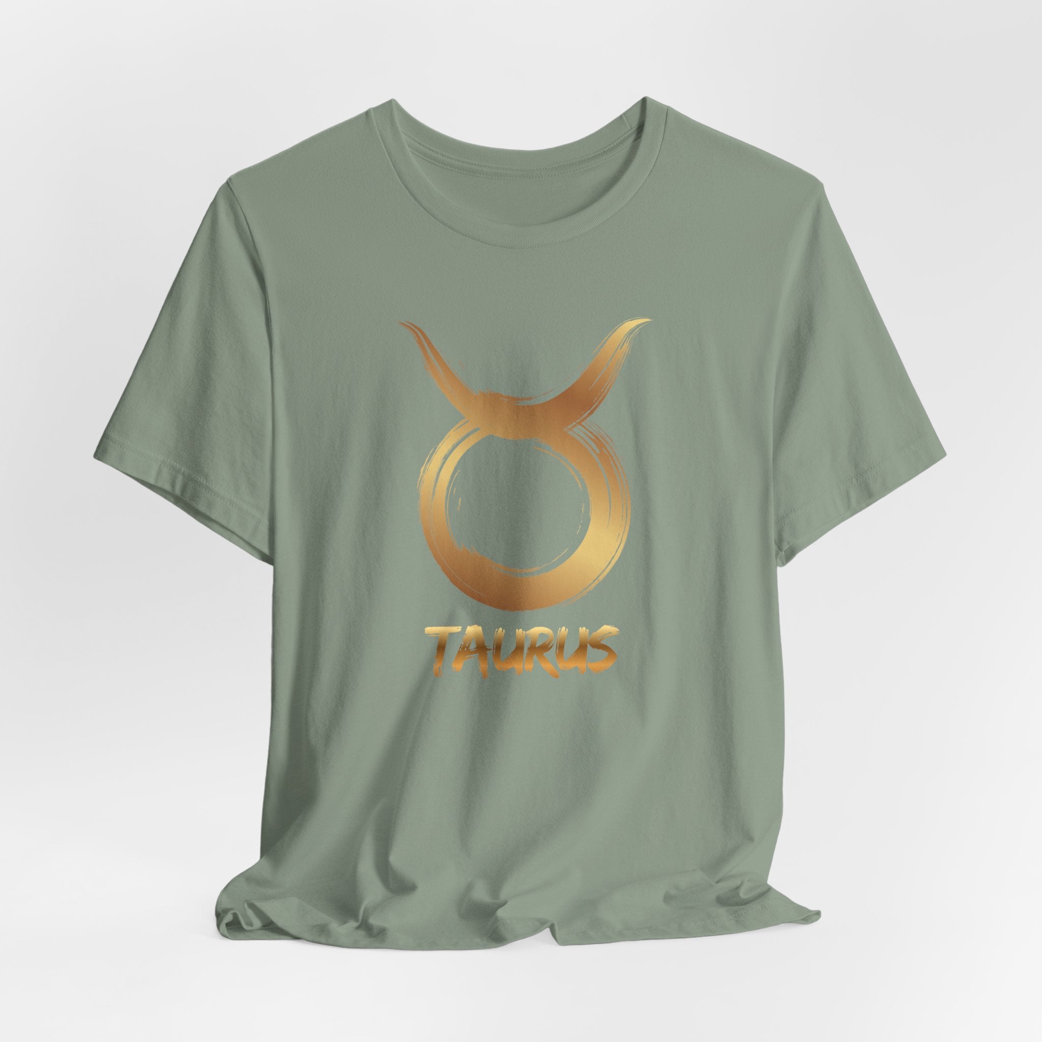 Green t-shirt with gold Taurus zodiac symbol on a light gray background