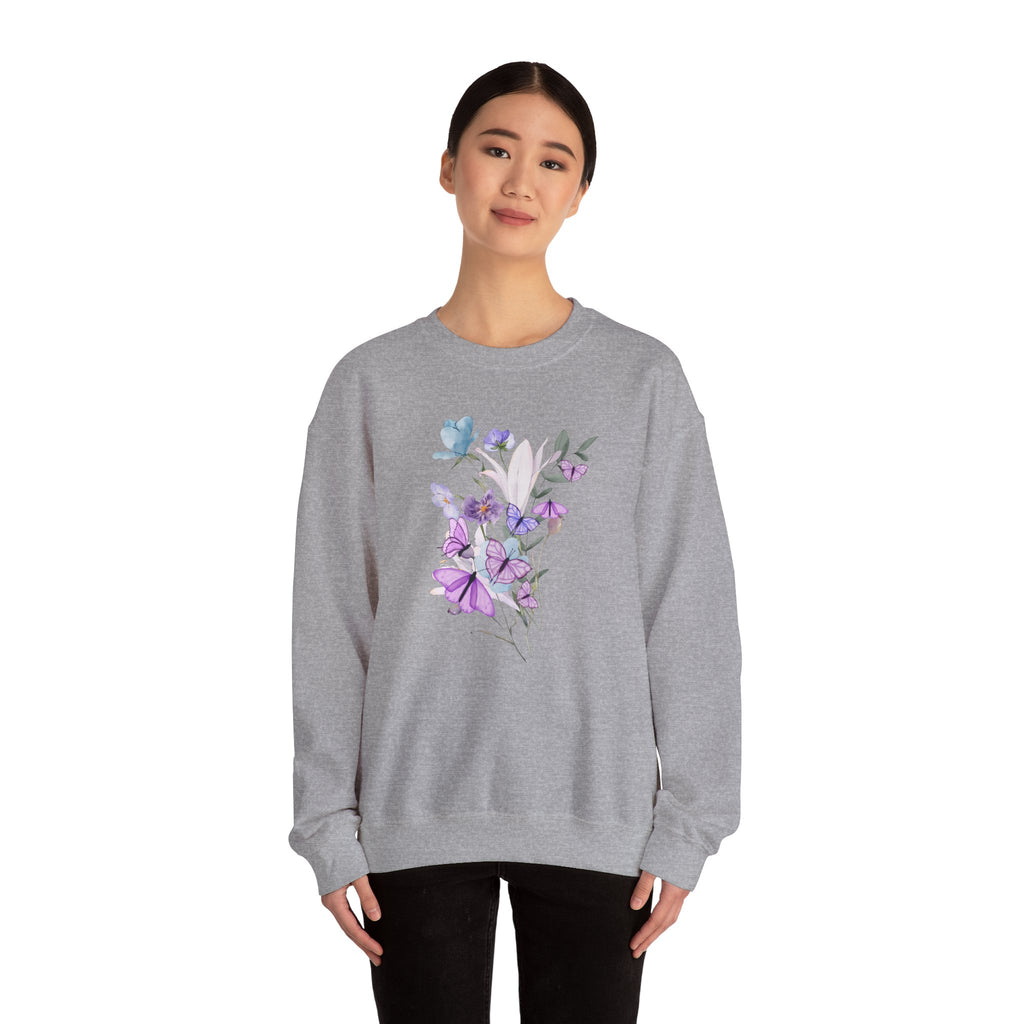 Person wearing a gray sweatshirt with floral design on a white background