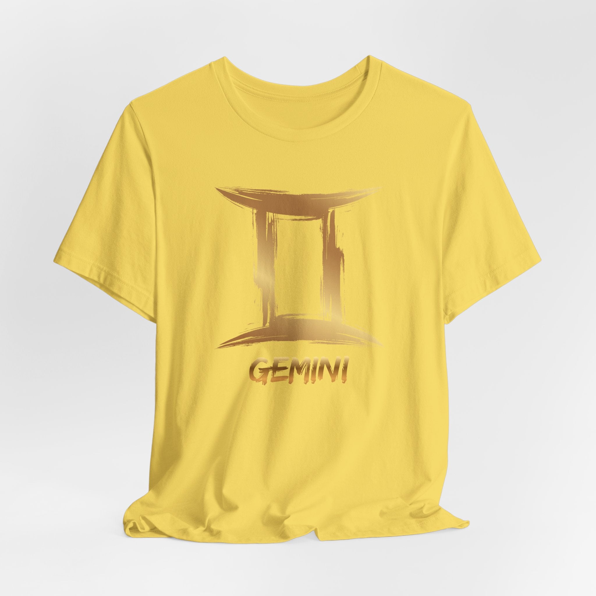 Yellow t-shirt with Gemini zodiac sign design on a light gray background