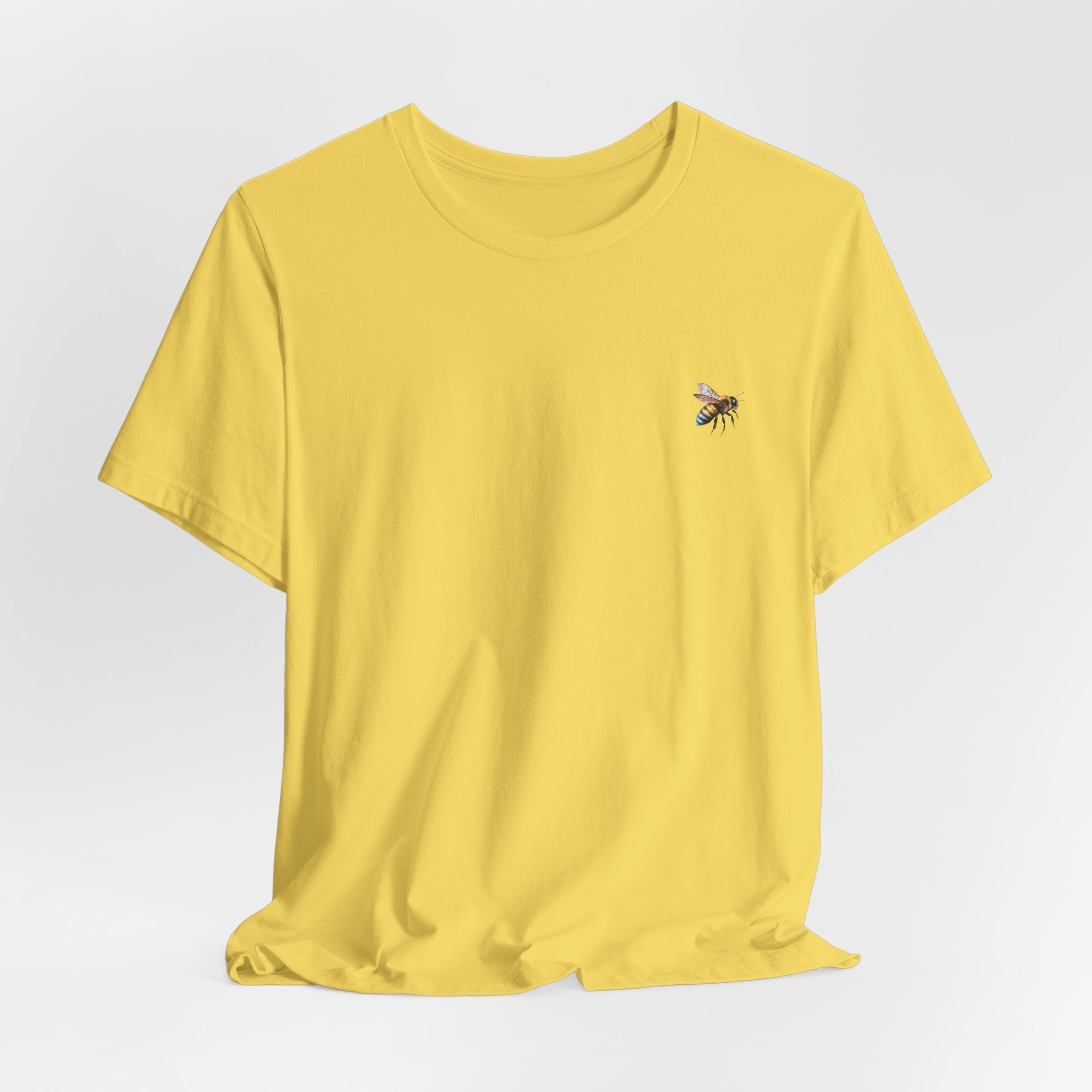 Yellow t-shirt with a bee design on a light gray background
