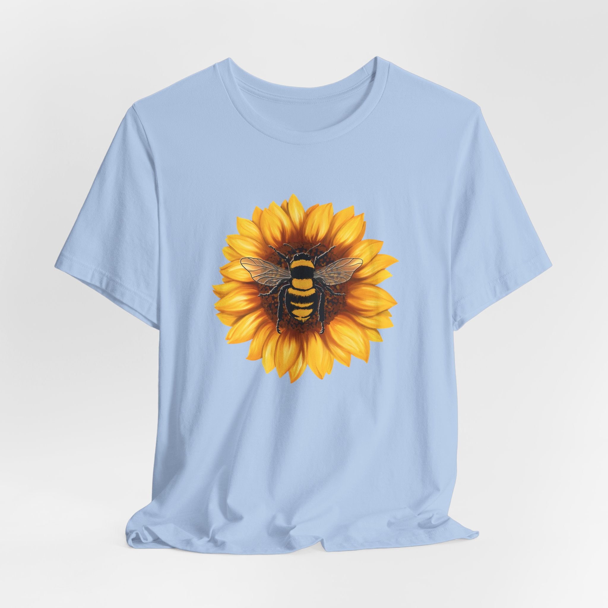 Light blue t-shirt with a sunflower and bee design on a white background