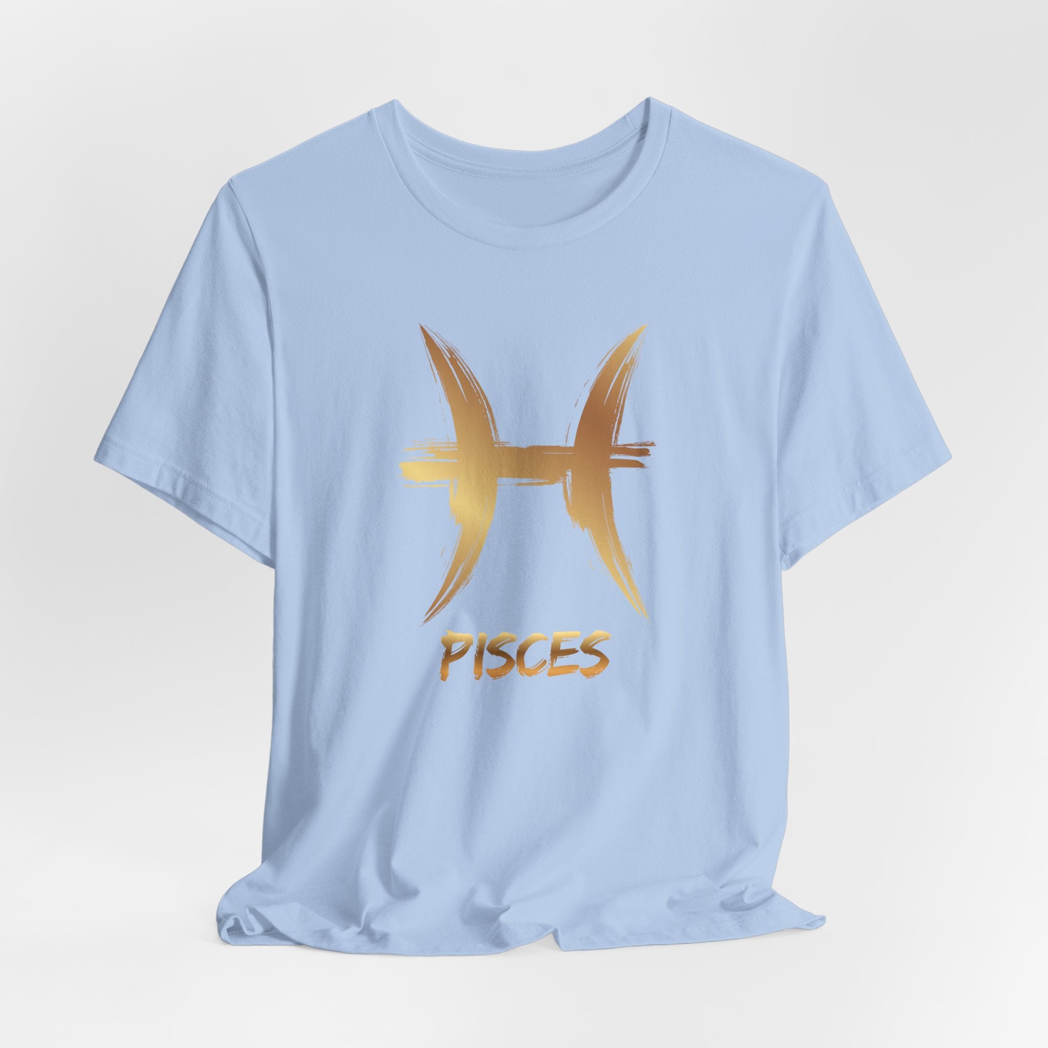 Light blue t-shirt with gold Pisces symbol and text on a light gray background