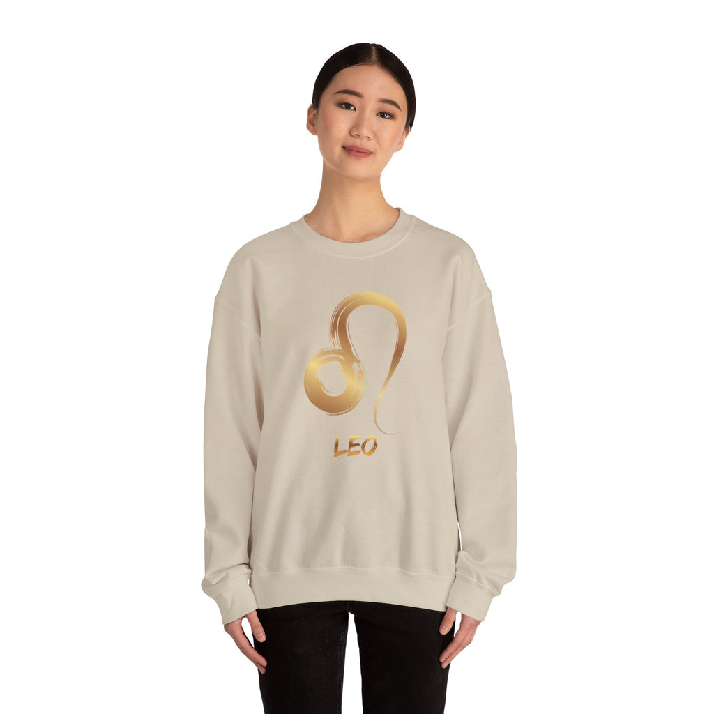 Person wearing a beige sweatshirt with a gold 'Leo' design on a white background