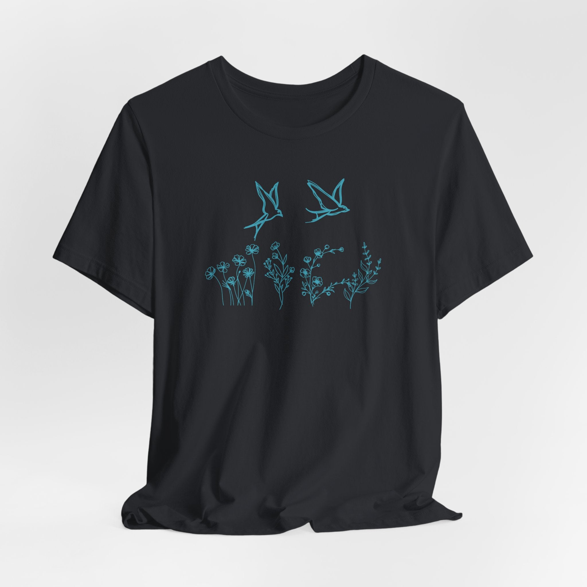 Black t-shirt with blue floral and bird design on a white background
