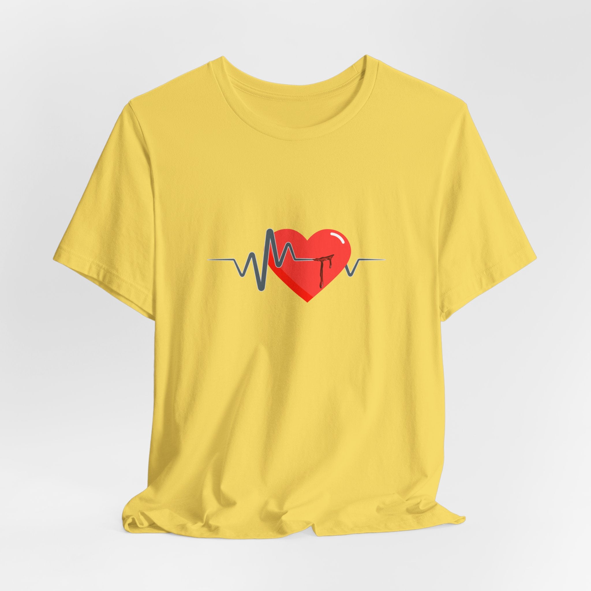 Yellow t-shirt with a red heart and black heartbeat line design on a light gray background