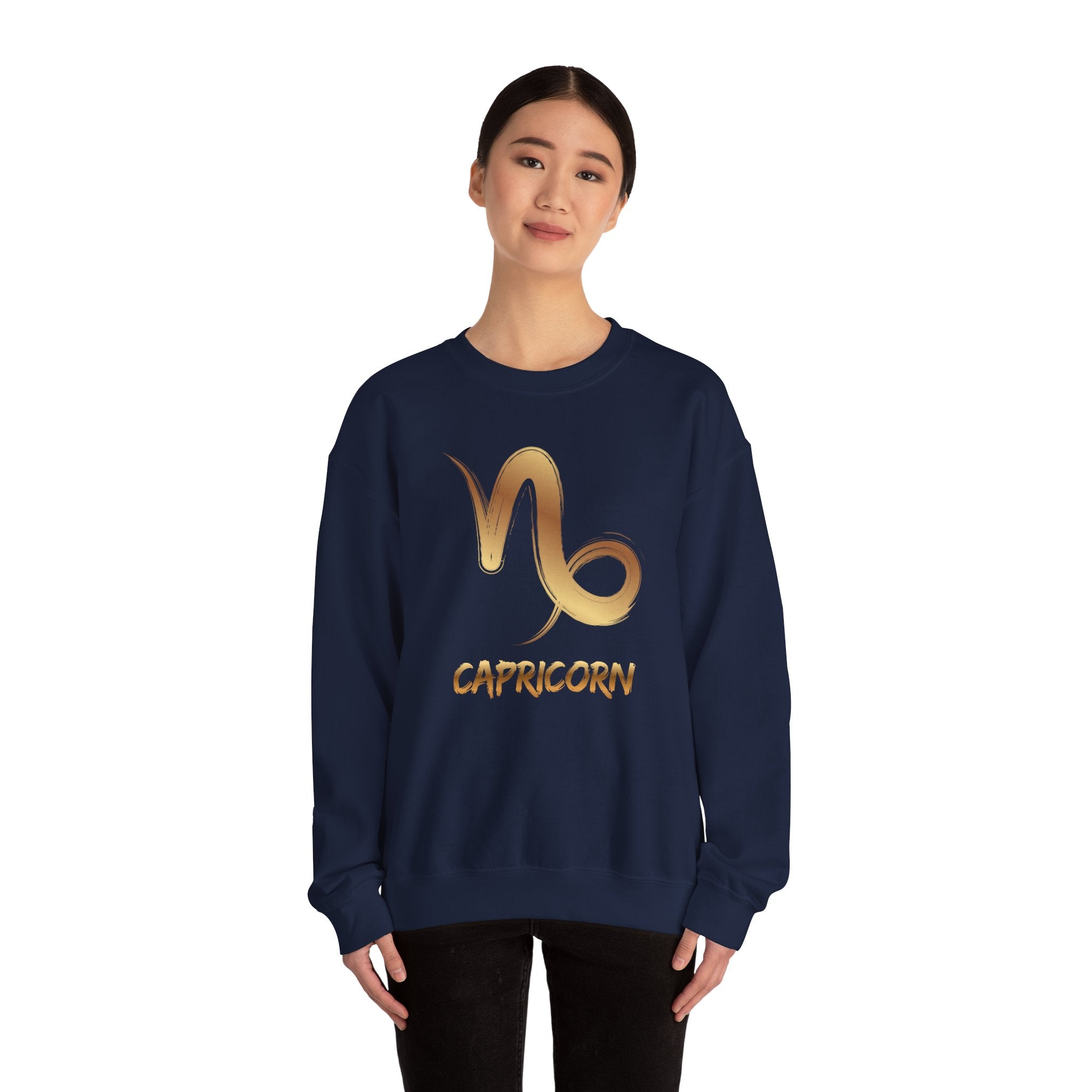 Person wearing a navy blue sweatshirt with Capricorn symbol and text on a white background