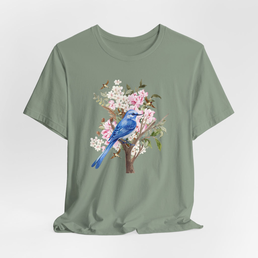 Green t-shirt with a blue bird and floral design on a light gray background