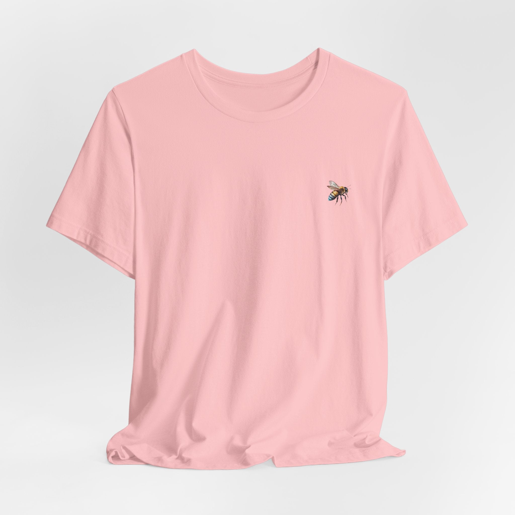 Pink t-shirt with bee graphic on a white background