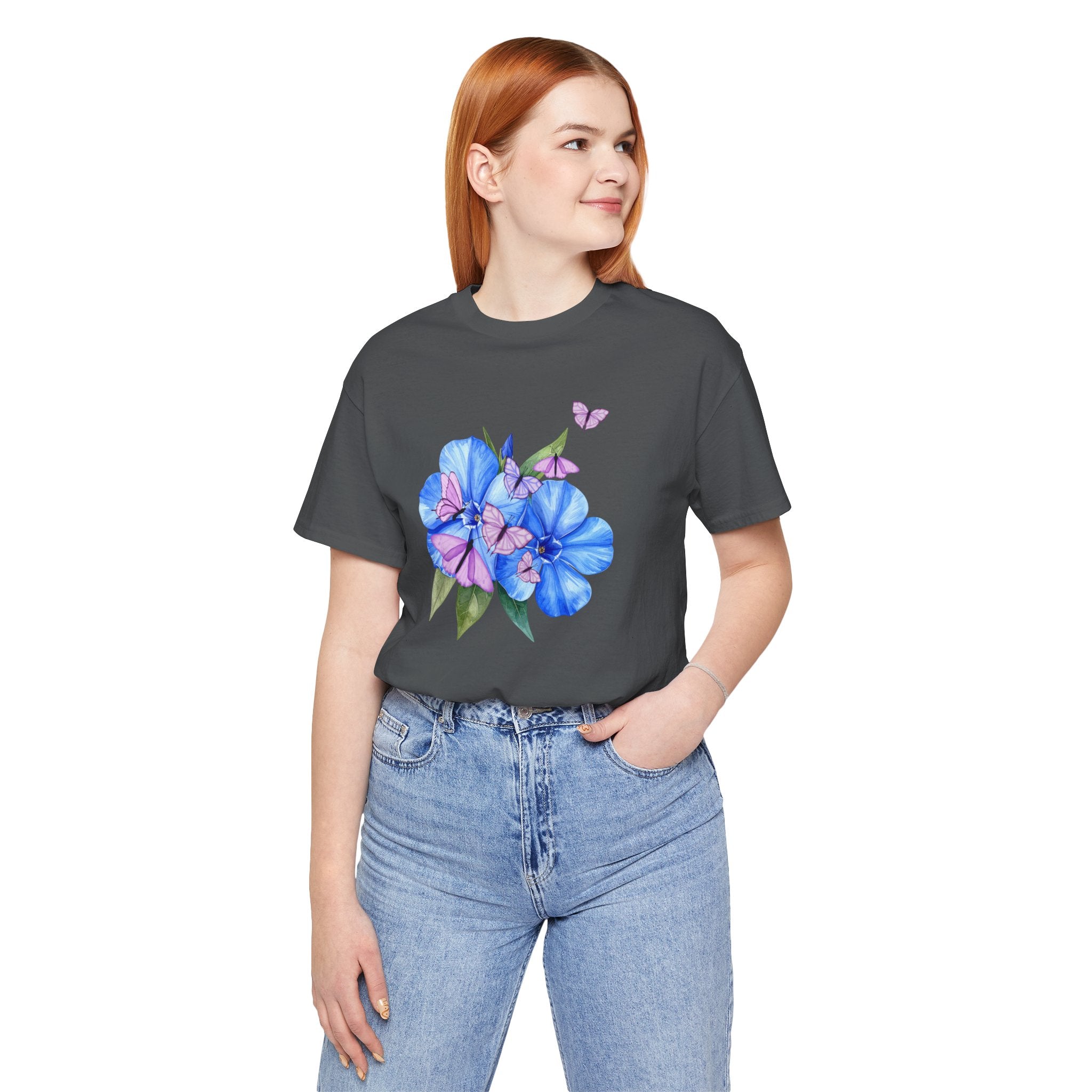 Person wearing a dark gray t-shirt with a floral design on a white background
