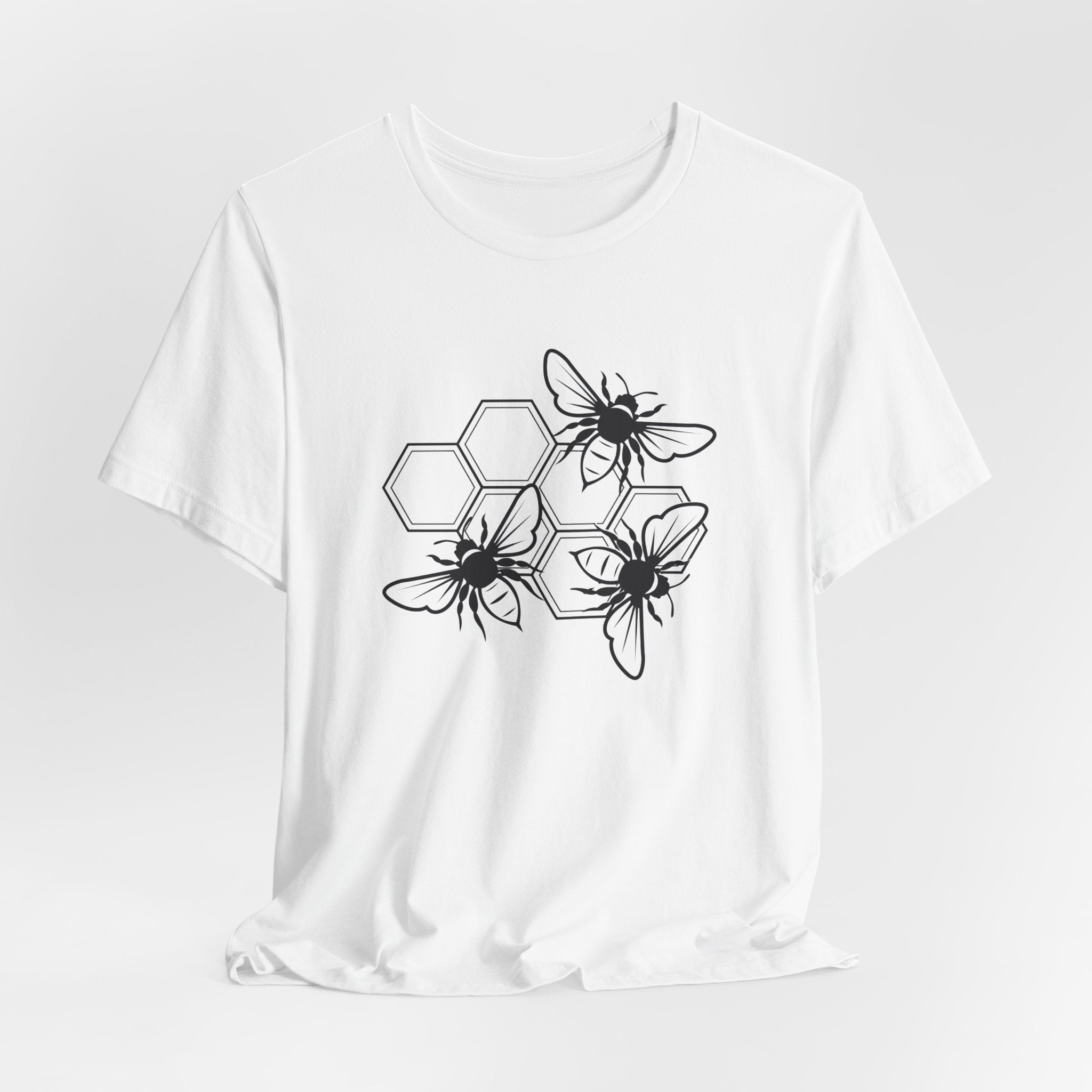 White t-shirt with black bee and hexagon pattern on a white background