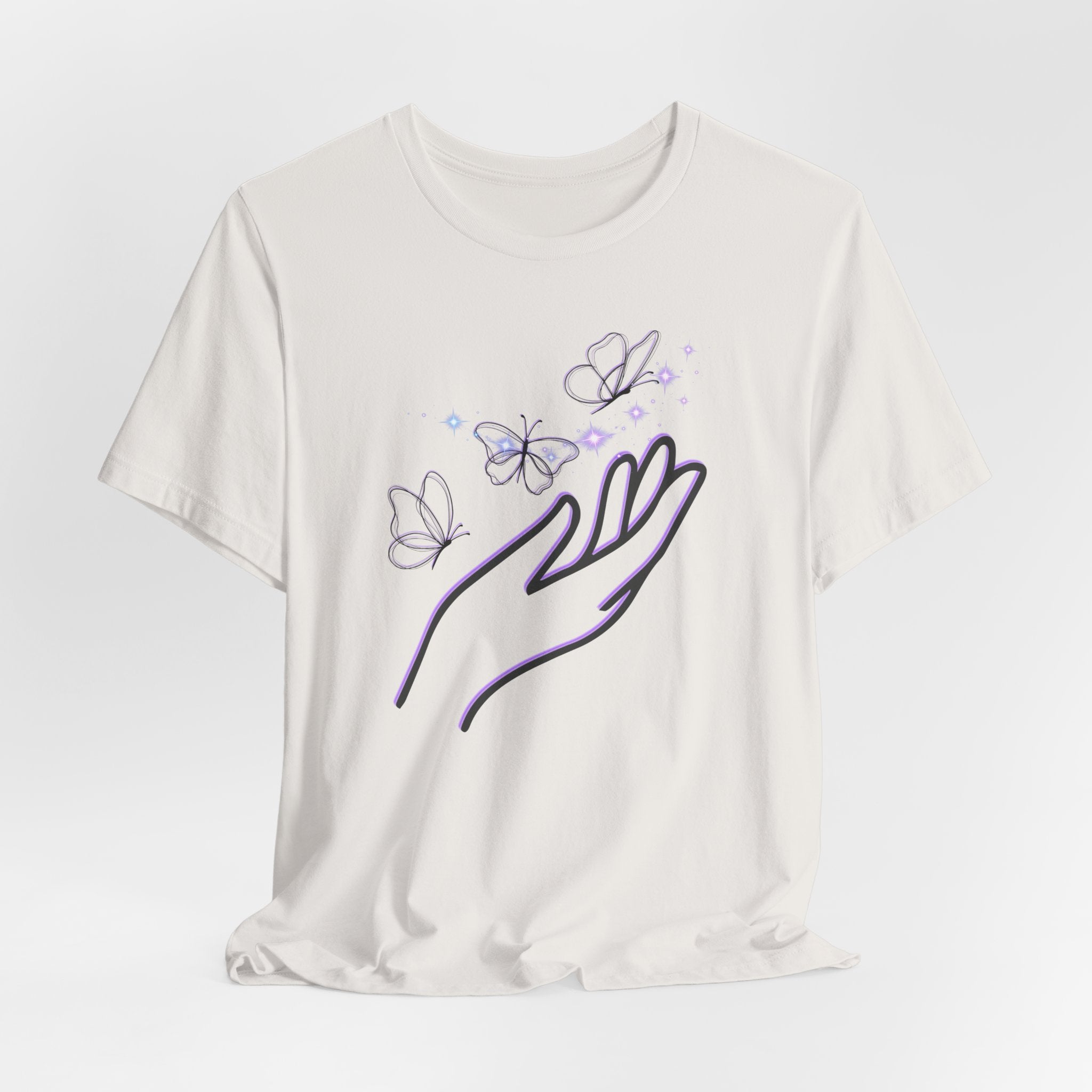 White t-shirt with a design of a hand holding butterflies on a light gray background