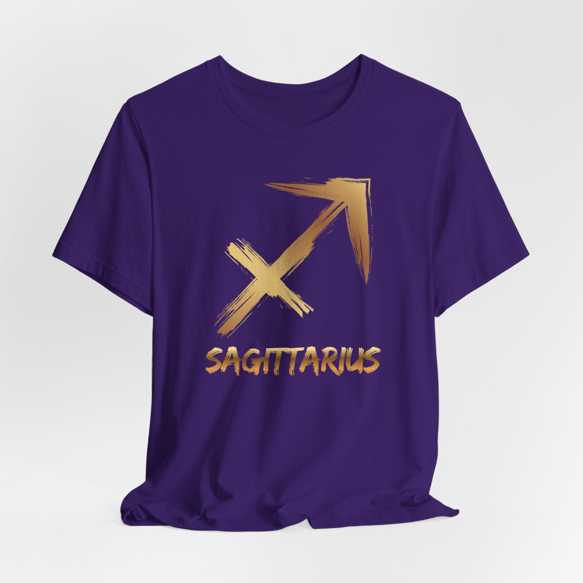 Purple t-shirt with gold Sagittarius symbol on a white background