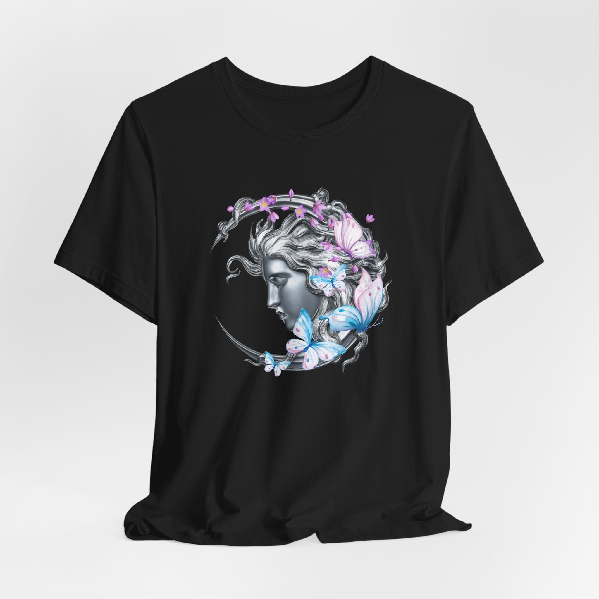 Black t-shirt with a decorative design of a woman's face with flowers and butterflies on a gray background