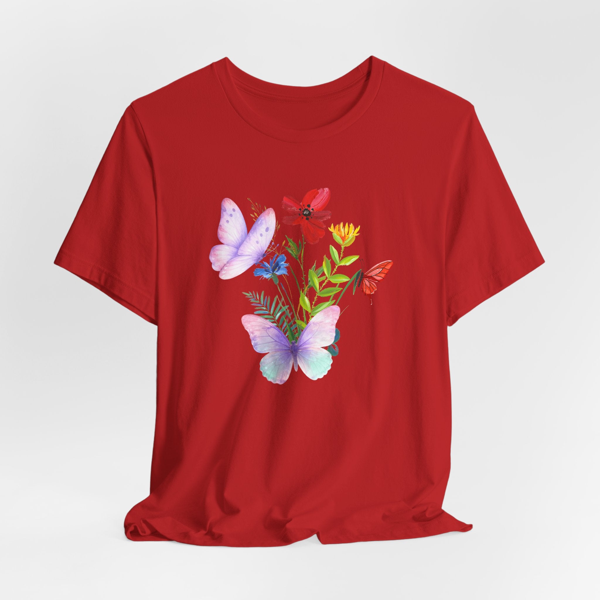 Red t-shirt with butterfly and floral design on a white background