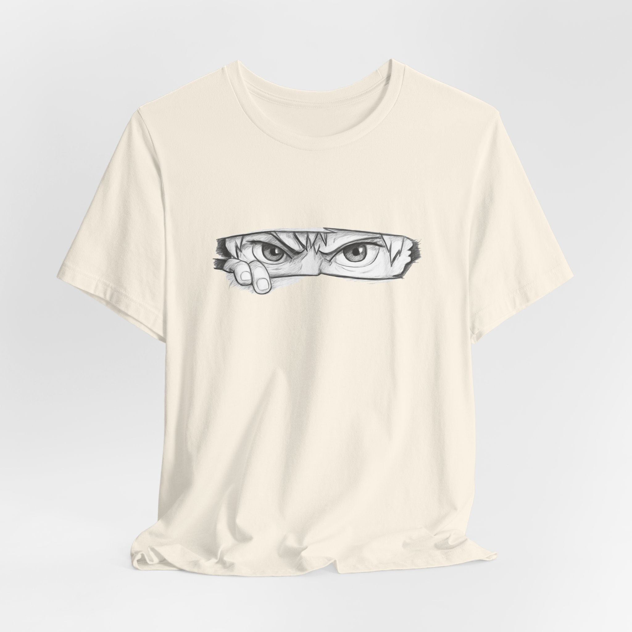 Beige t-shirt with a graphic of a face on a light gray background