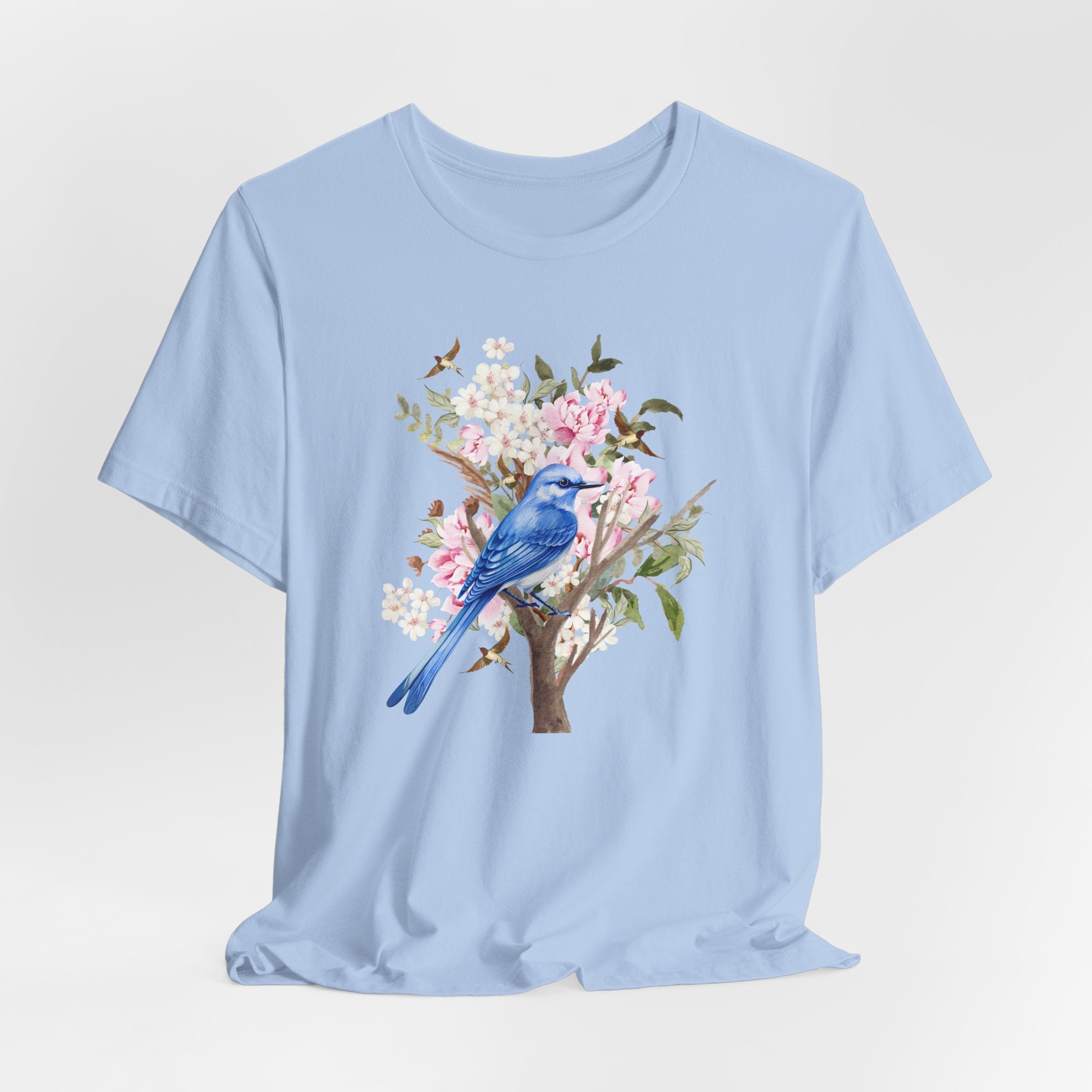 Light blue t-shirt with a bird and floral design on a light gray background