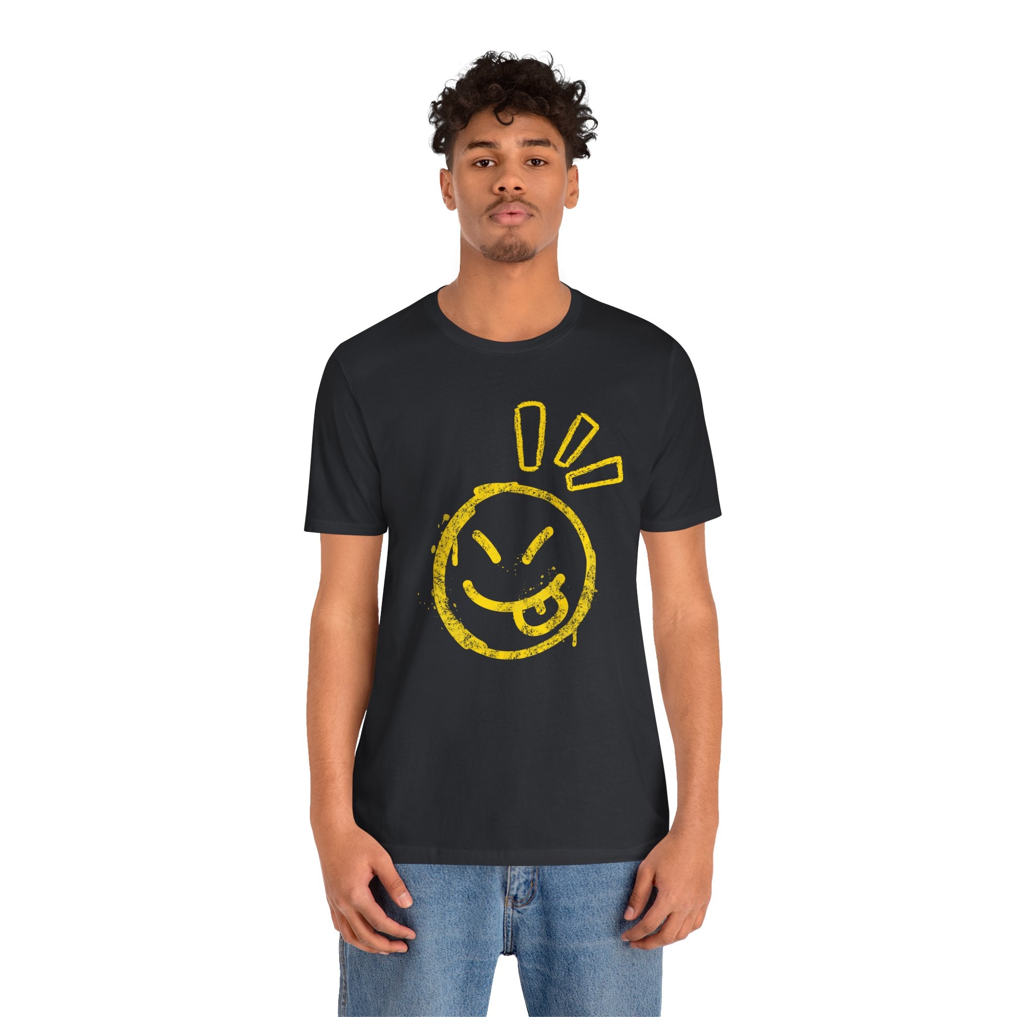 Person wearing a black t-shirt with a yellow smiley face design on a white background