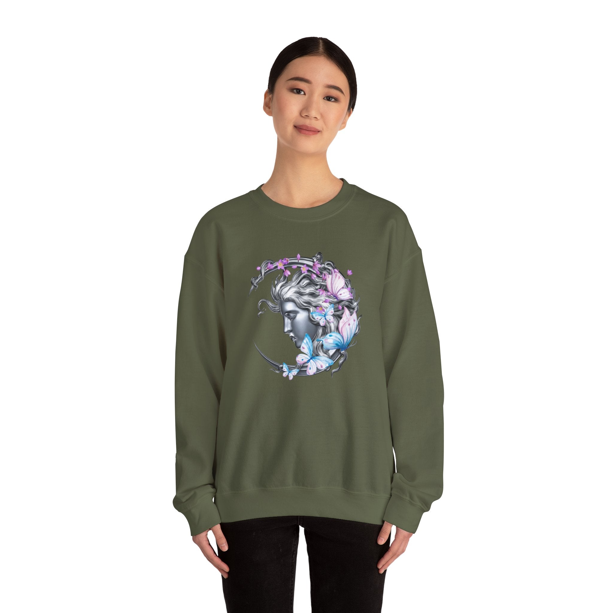 Person wearing a green sweatshirt with a graphic design of a woman's face surrounded by butterflies on a white background