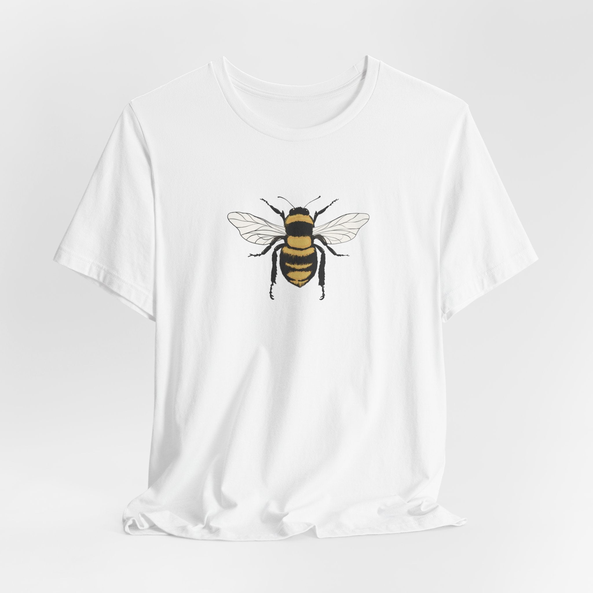 White t-shirt with a bee graphic on a light gray background