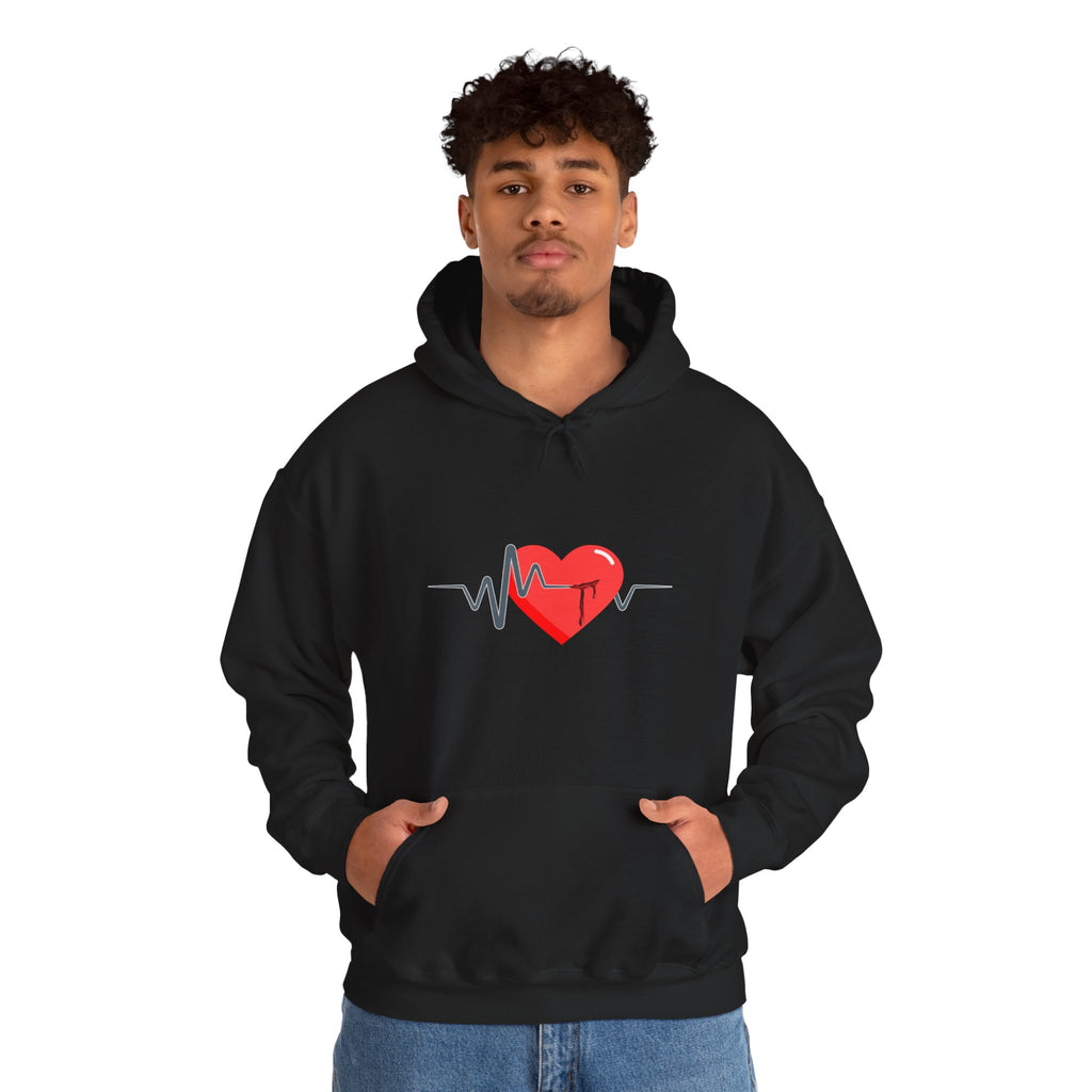 Person wearing a black hoodie with a red heart and heartbeat line design on a white background