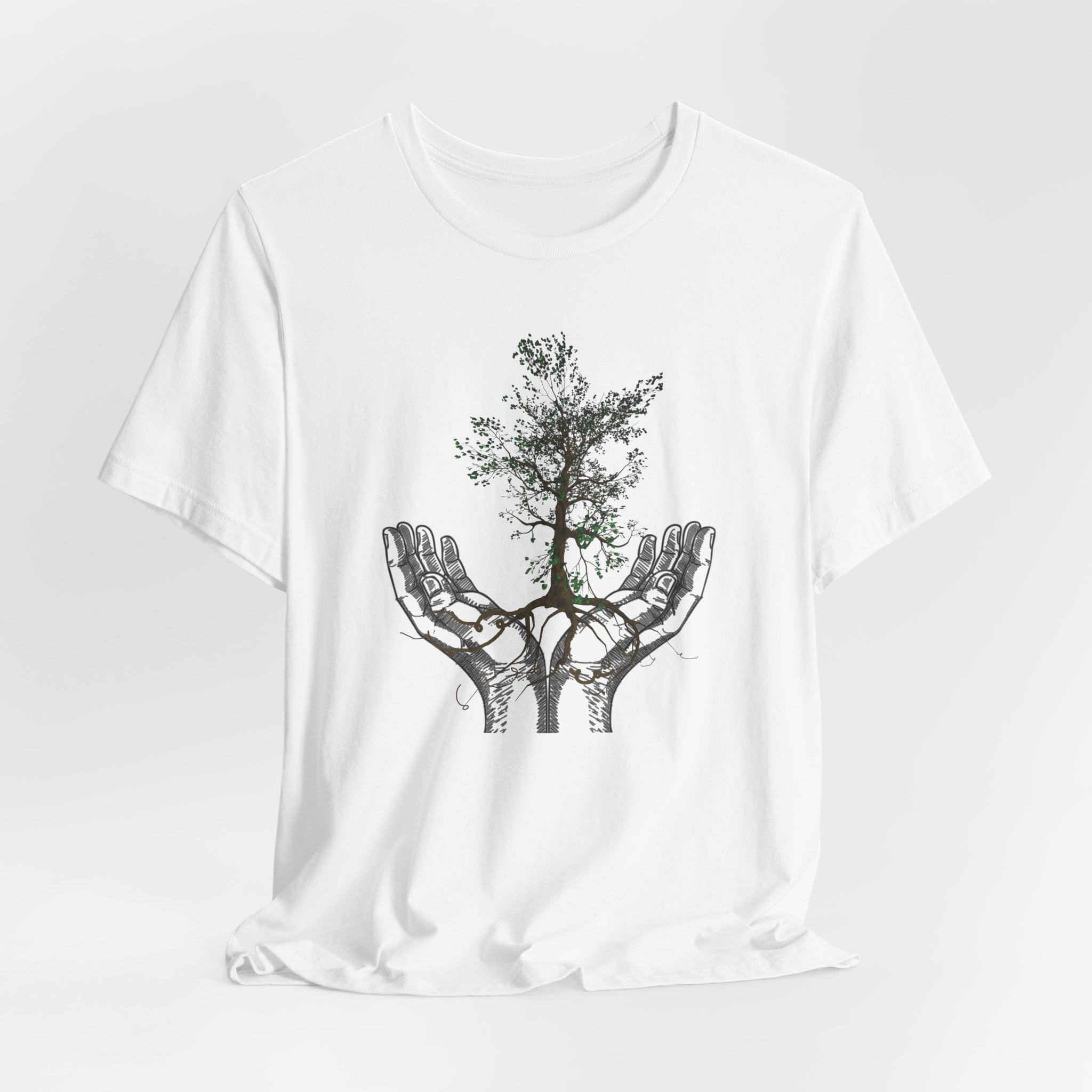 White t-shirt with a black tree design in hands on a white background