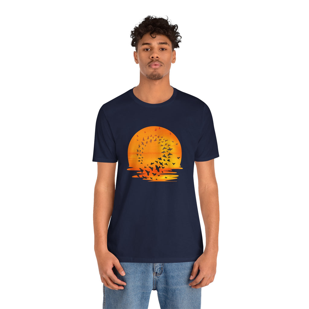 Person wearing a navy blue t-shirt with a sunset graphic design on a white background