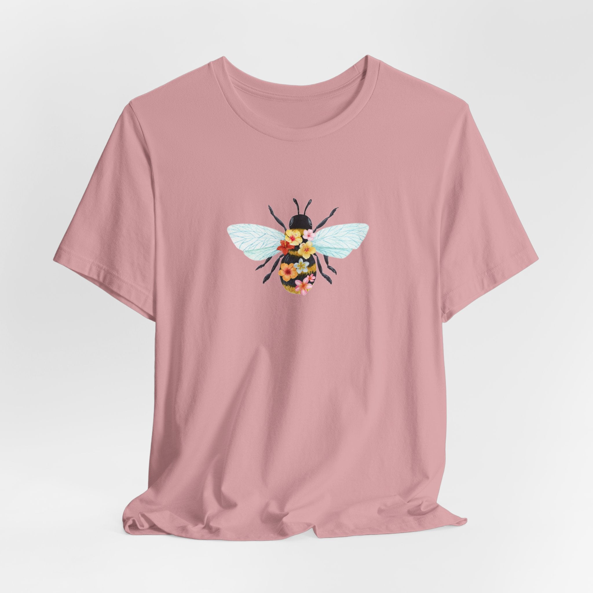 Pink t-shirt with a bee design on a light gray background