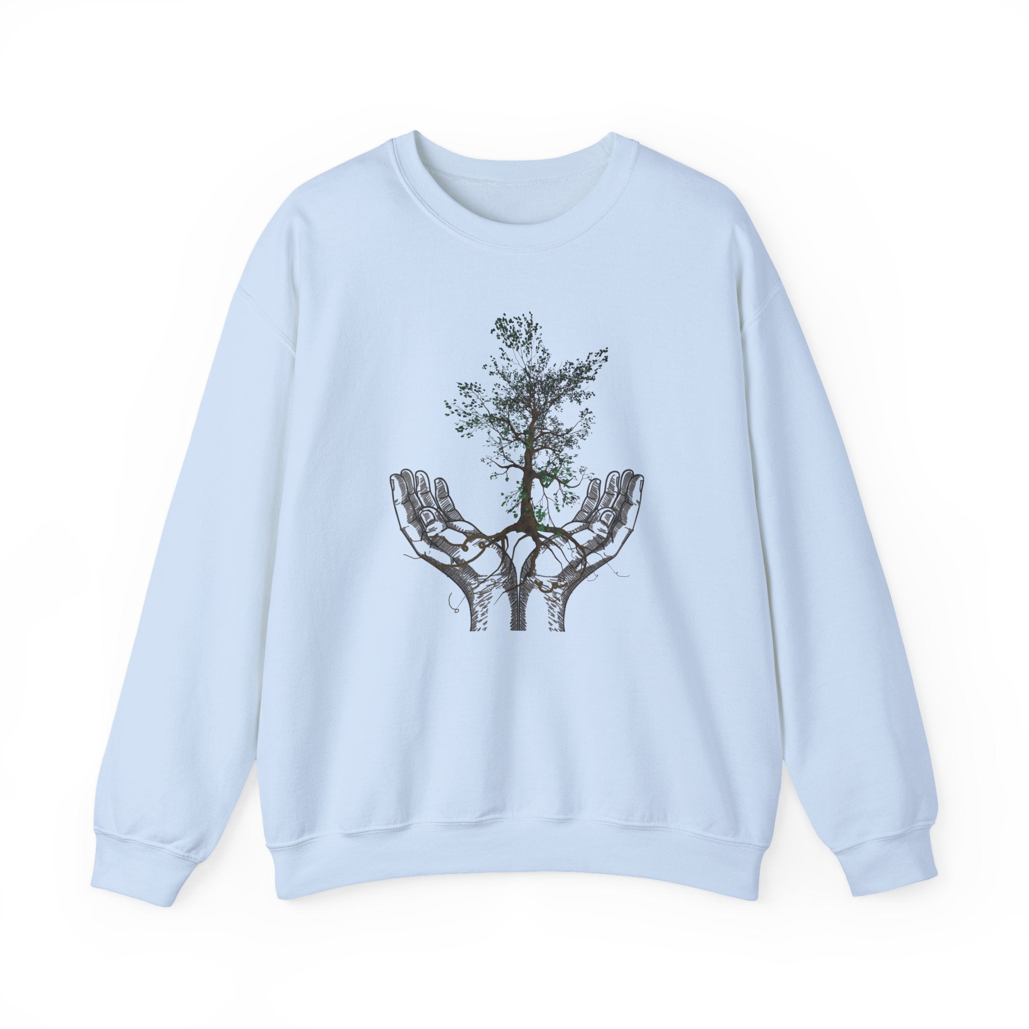Light blue sweatshirt with a tree design in hands on a white background