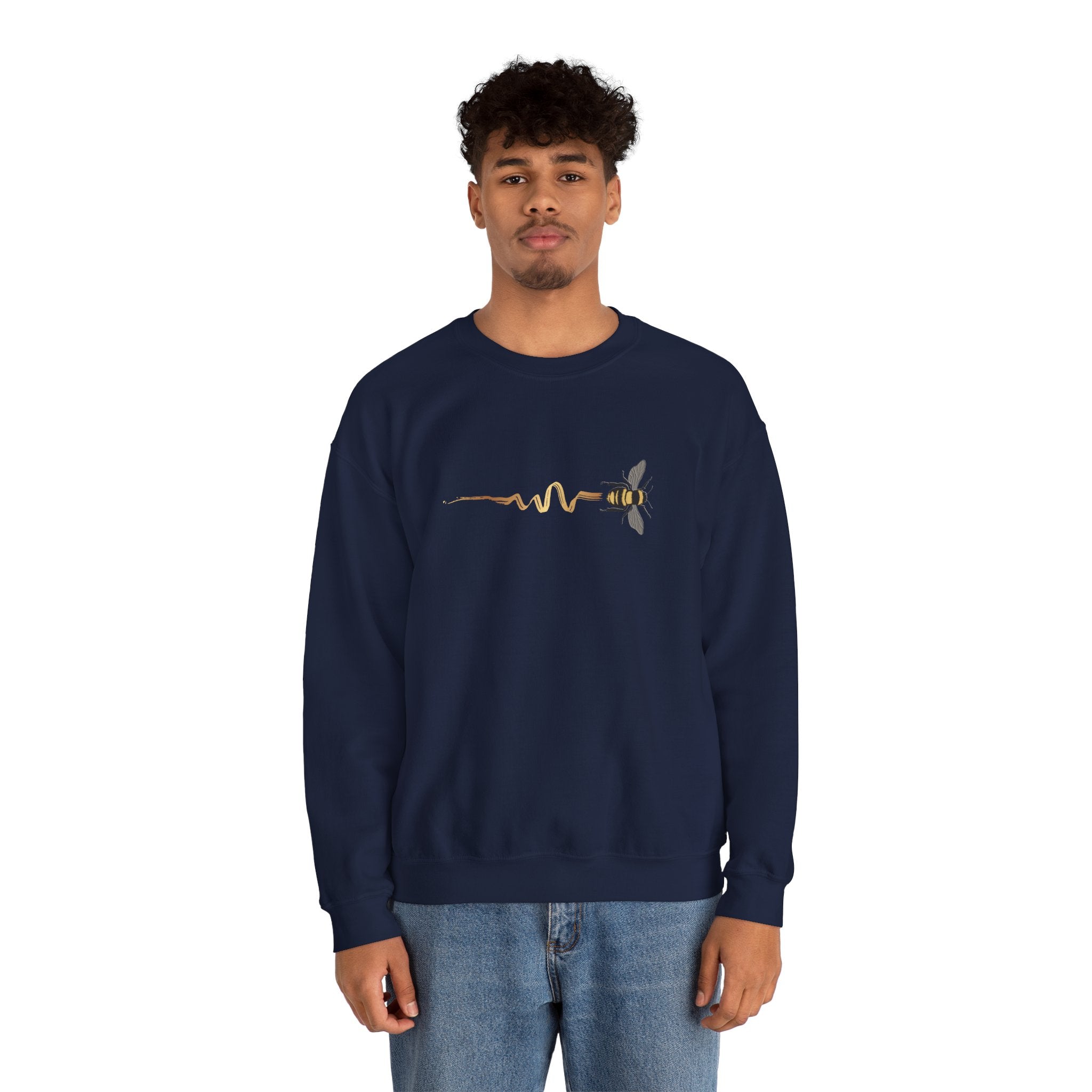 Person wearing a navy blue sweatshirt with a bee design on a white background
